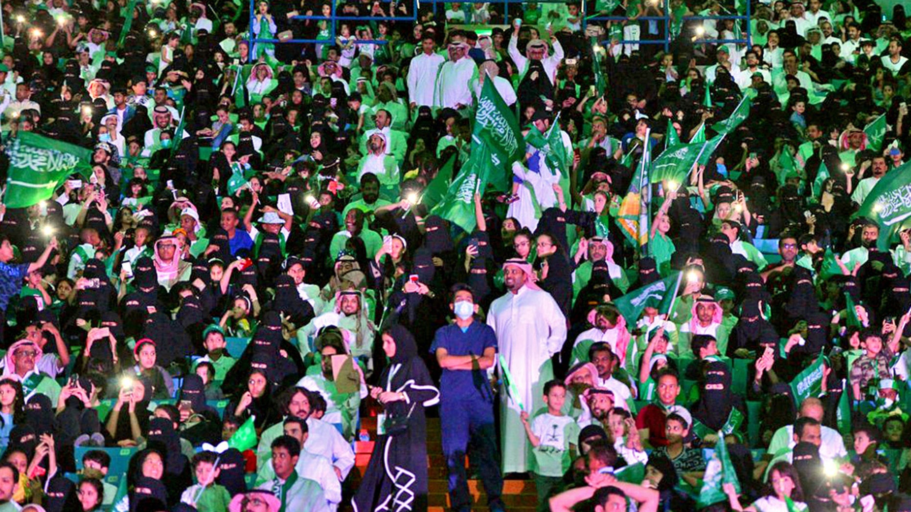 Saudi men and women attend national day ceremonies at the King Fahd stadium in Riyadh.