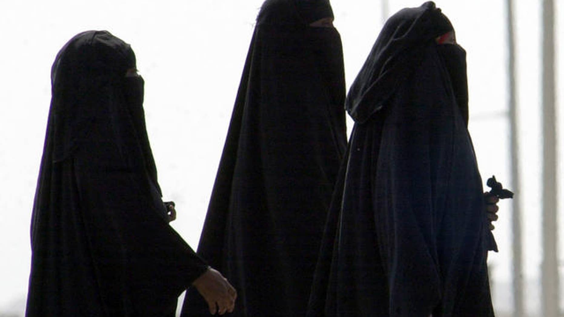 2006 FILE photo of unidentified Saudi women walking along a suburban street in Riyadh, Saudi Arabia.