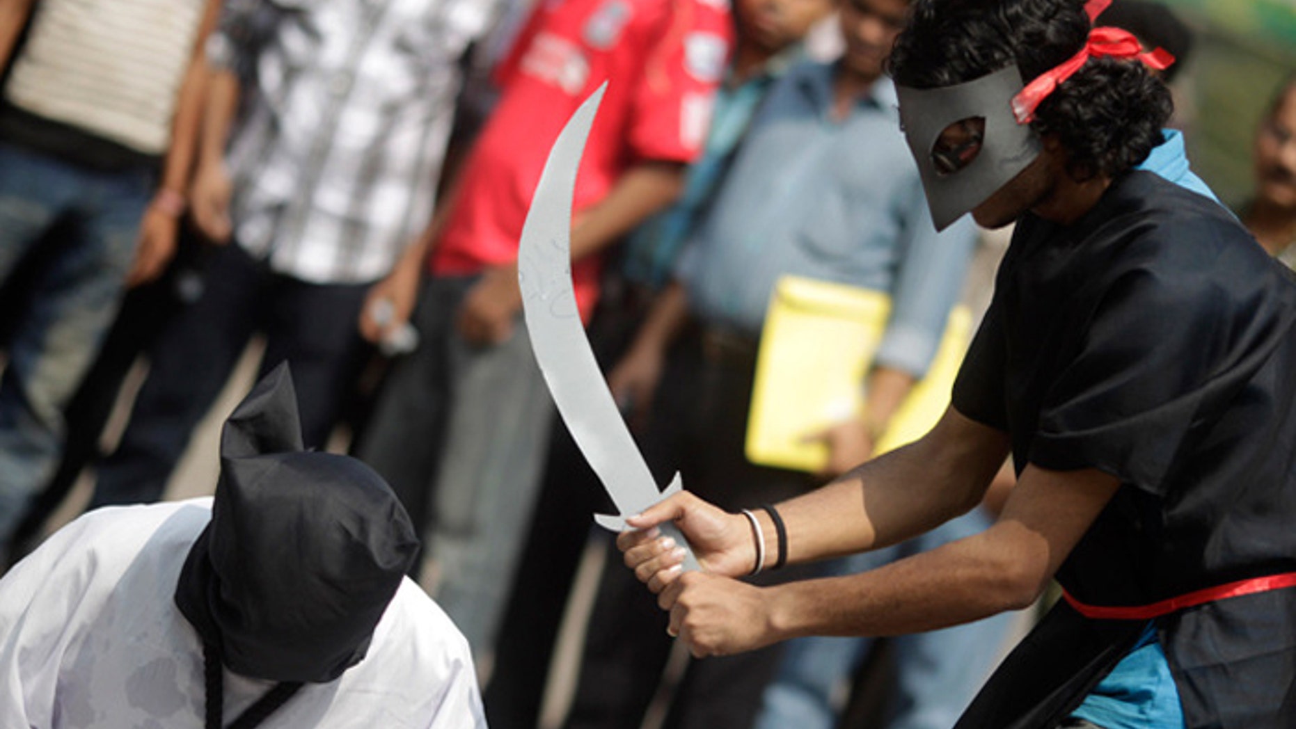 Demonstrators stage a mock beheading to protest executions in Saudi Arabia (Reuters)