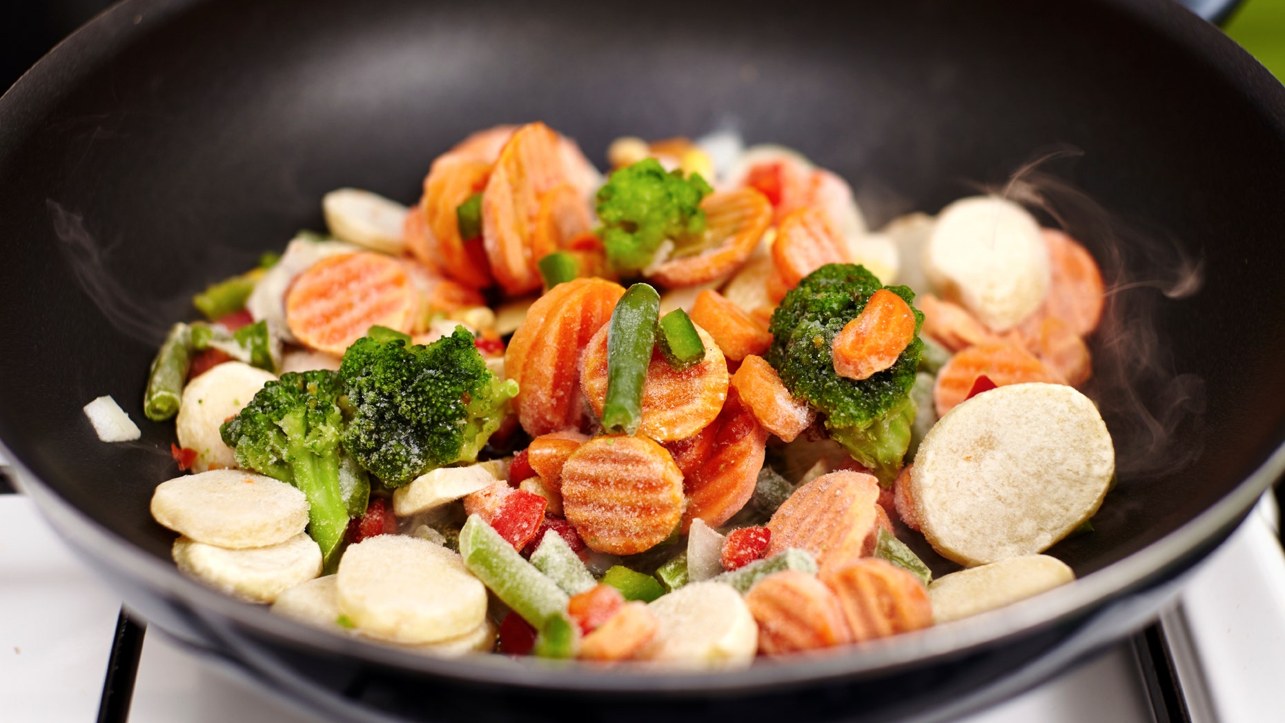 Closeup of frozen vegetables mix (broccoli, carrots, potatoes, peas)