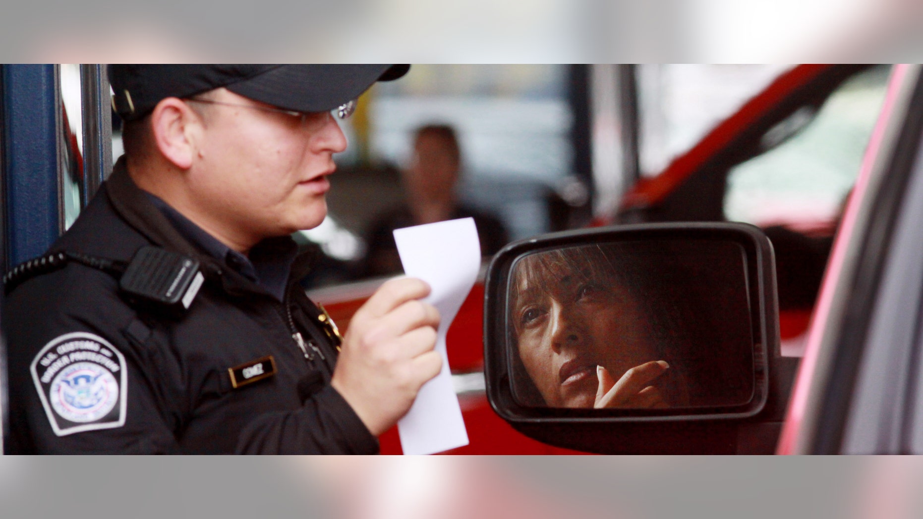 SAN YSIDRO, CA-, JUNE 1: Customs and Border Protection agent Jesus Gomez checks a passport at the vehicle crossing at the San Ysidro Port of Entry June 1, 2009 in San Ysidro, California. The Western Hemisphere Iniative (WHTI) was put into effect today at all Canadian and Mexican border crossings where visitors and residents must present an approved travel document when entering the U.S. at any land or sea ports of entry. These travel documents include a U.S. passport or passport card, as well as a Trusted Traveler Card (SENTRI, NEXUS or FAST) or an Enhanced Driver's License. (Photo by Sandy Huffaker/Getty Images)