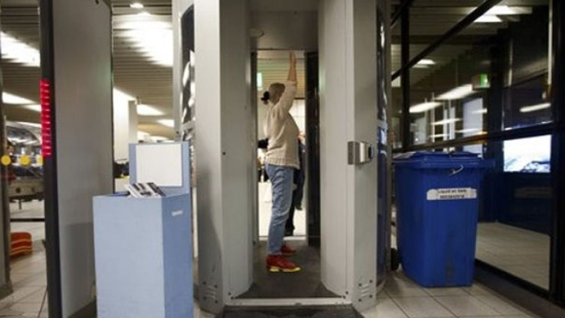 A passenger is screened inside a body scanner at Schiphol airport, Netherlands, Dec. 28. (AP Photo)