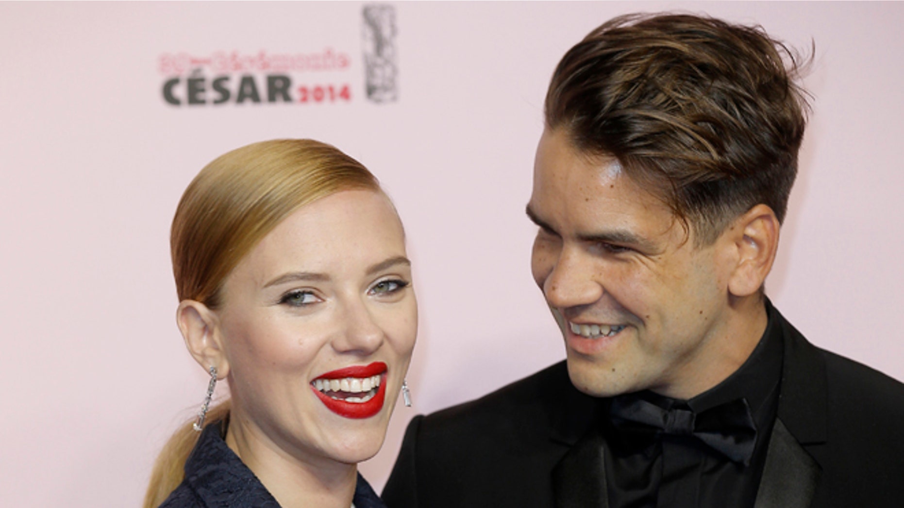 Feb. 28, 2014: Actress Scarlett Johansson, left, and her partner Romain Dauriac arrive at the 39th French Cesar Awards Ceremony, in Paris.