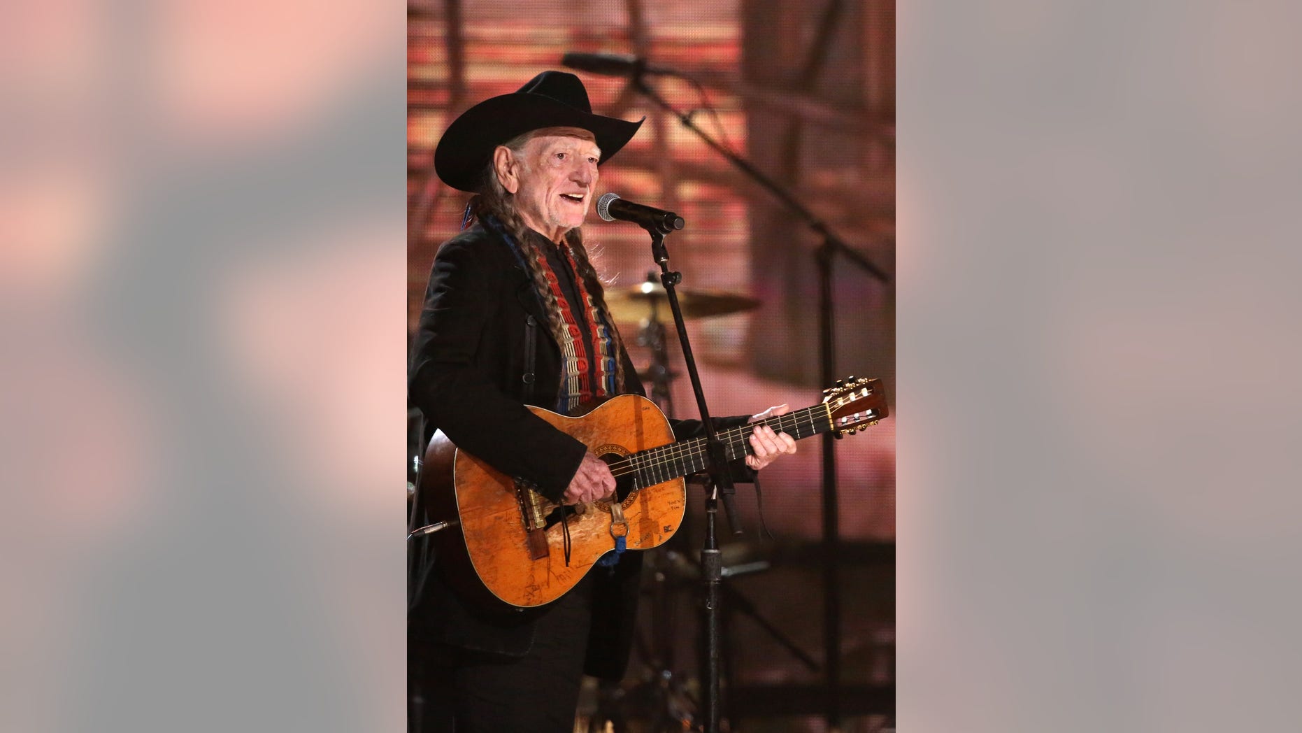 Willie Nelson performs on stage at the 56th annual Grammy Awards at Staples Center on Sunday, Jan. 26, 2014, in Los Angeles. (Photo by Matt Sayles/Invision/AP)