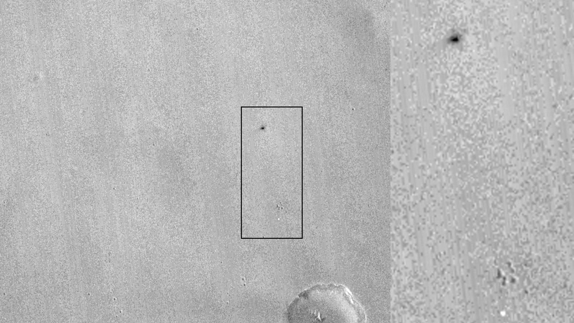 This image by NASA's Mars Reconnaissance Orbiter shows what appears to be the ExoMars lander's parachute (bright spot at bottom) and the impact site of the lander itself (dark patch at top).