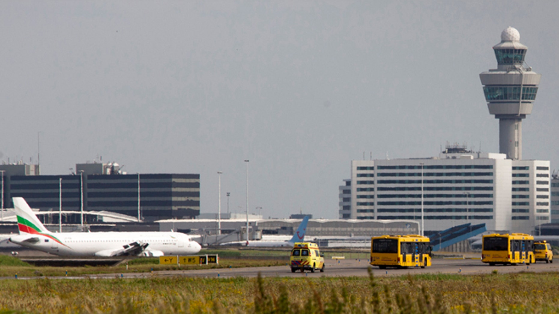 August 29, 2012: Passengers from a Vueling plane leave in a bus at Amsterdam's Schiphol Airport, Netherlands.