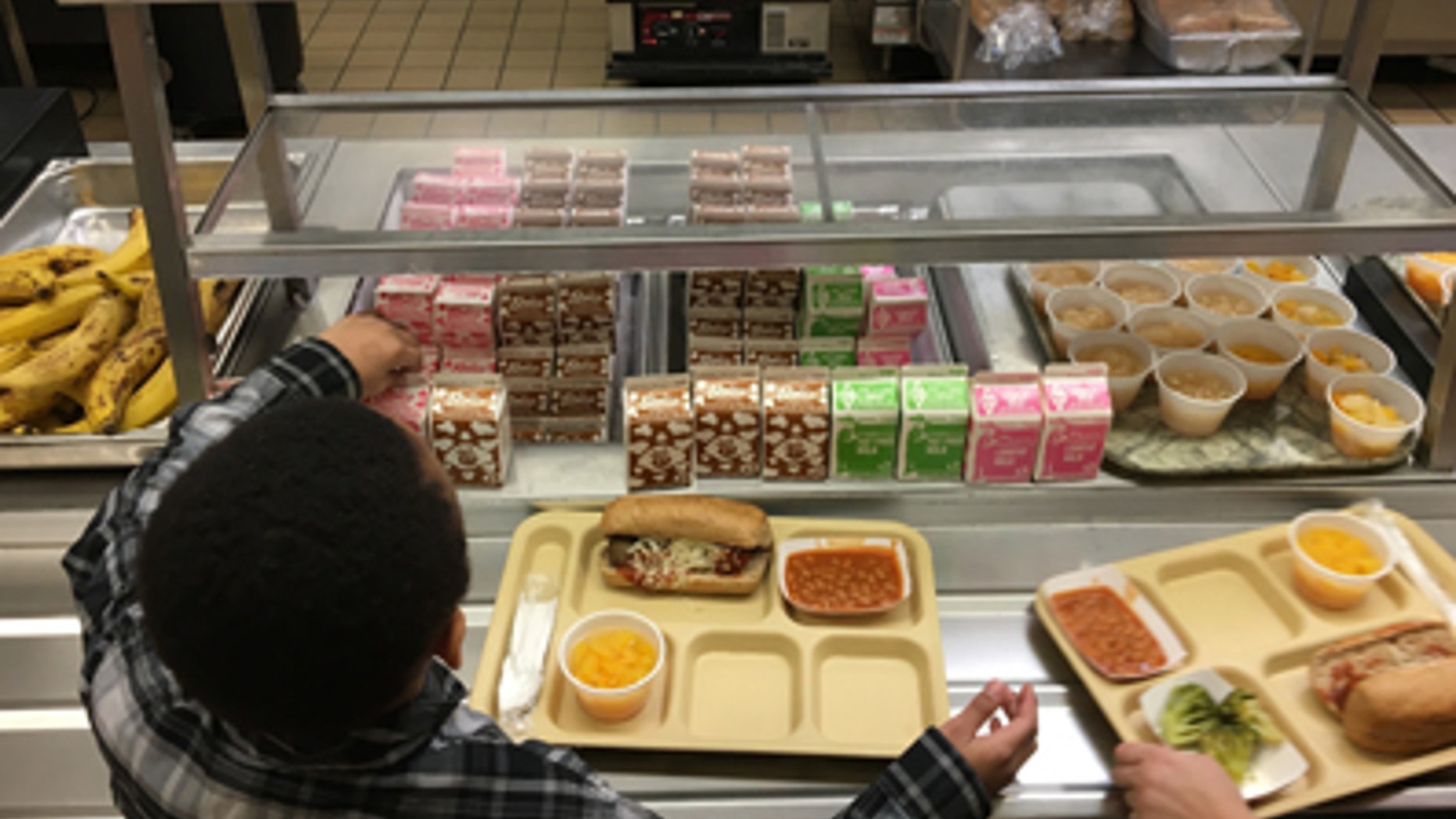 Students fill their lunch trays at J.F.K. Elementary School in Kingston, N.Y.
