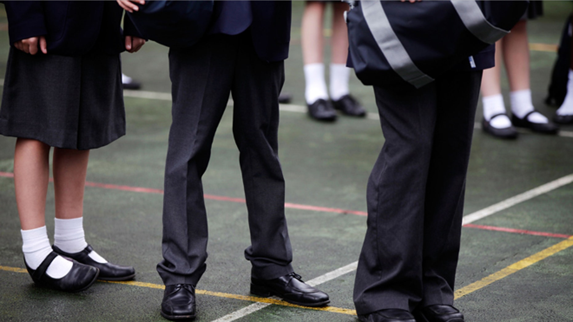 LONDON, ENGLAND - SEPTEMBER 09: Pupils wait for school buses in the playground after the Mayor of London opened the West London Free School on September 9, 2011 in London, England. The free school, one of the first semi-independent taxpayer-funded schools set up by groups of teachers and parents, is an 11-18 secondary school. It will teach a classical liberal syllabus, with latin compulsory to age 14 with its stated aim to be a "grammar school for all", MP Harold Wilson's original definition of a comprehensive school. (Photo by Matthew Lloyd/Getty Images)