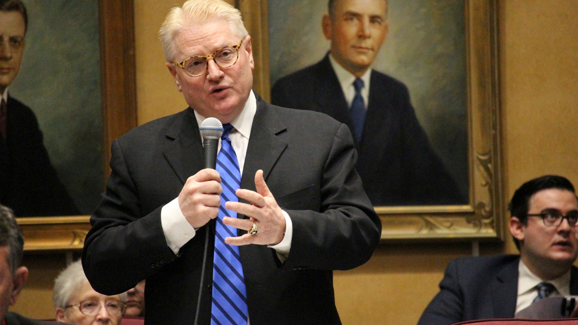 Republican state Sen. Bob Worsley, standing, explains a deal he negotiated to cap overall growth in a proposal expanding Arizona's private school voucher program to all students Thursday, April 6, 2017, in Phoenix. (AP Photo/Bob Christie)
