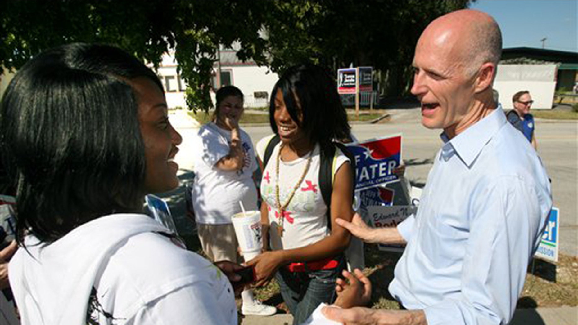Republican gubernatorial nominee Rick Scott talks to young supporters during a campaign stop at the VFW post in Apopka, Fla., on the first day of early voting Oct. 18. (AP Photo)