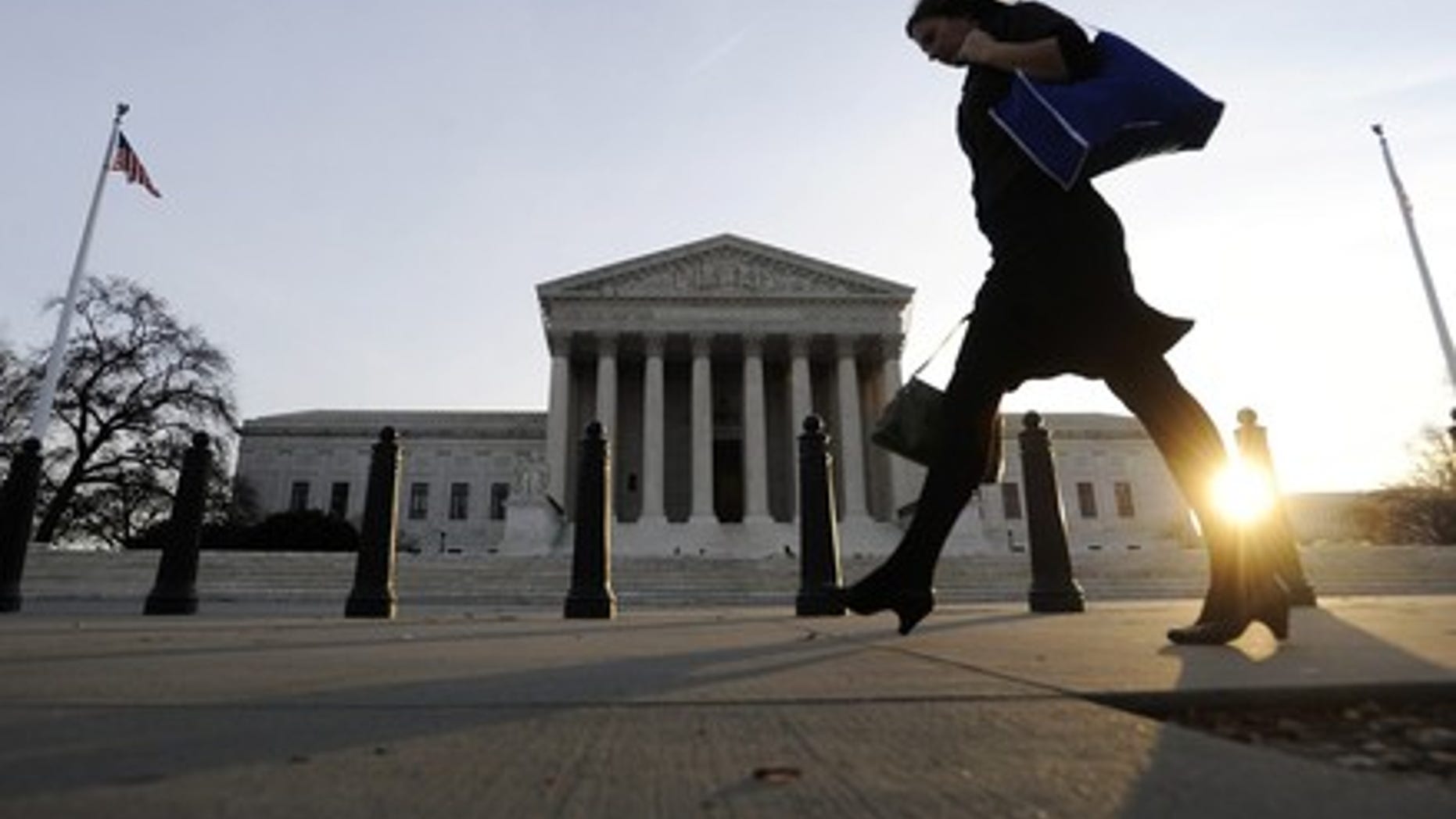 FILE -- A pedestrian walks past the US Supreme Court building in Washington. (REUTERS)