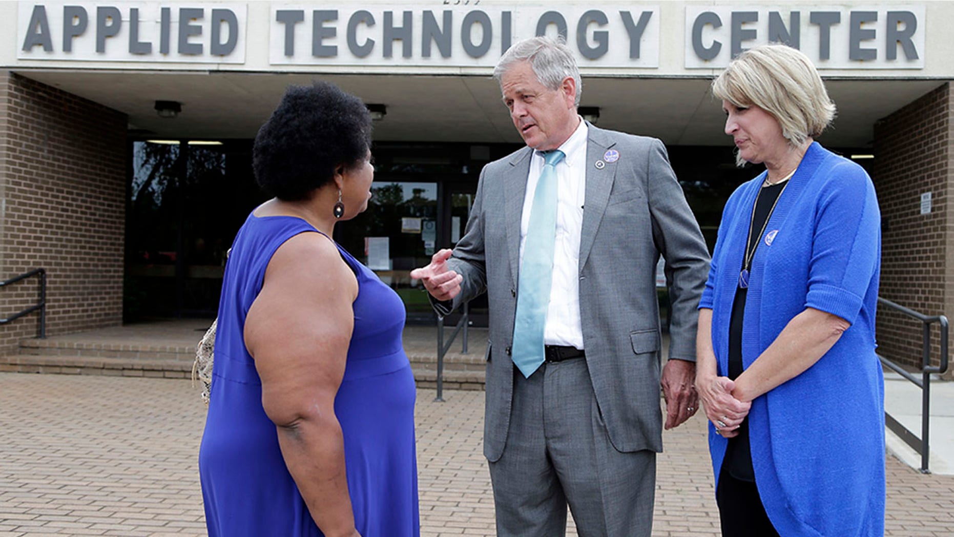 Republican candidate for U.S. Congress Ralph Norman, center, speaks with Gladys Jackson, left, as Norman's wife, Elaine, right, looks on at a polling place in South Carolina's 5th Congressional District in Rock Hill, S.C.