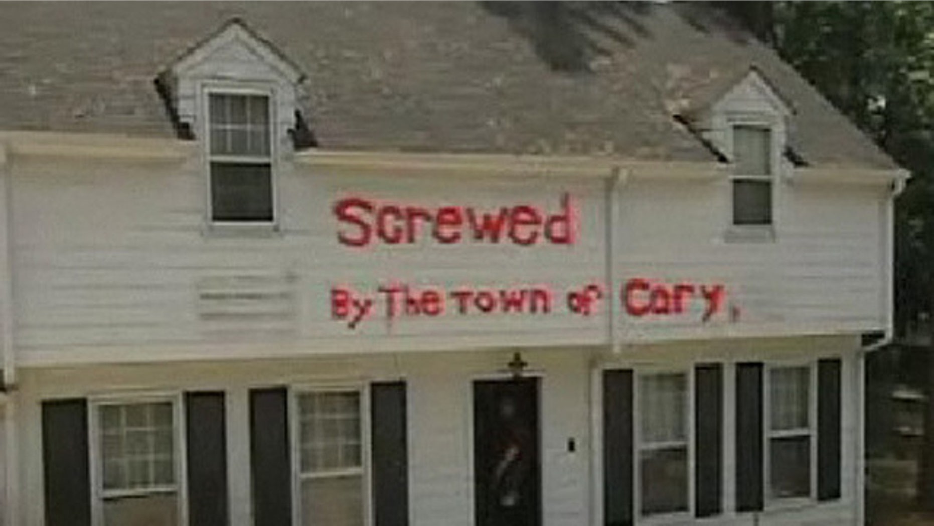 In 2009, David Bowden sued when town officials tried to fine him for a sign in his yard that read "Screwed by the town of Cary" painted in neon orange. Bowden claims his home was damaged by runoff that he blames on local road construction. (MyFox8.com)