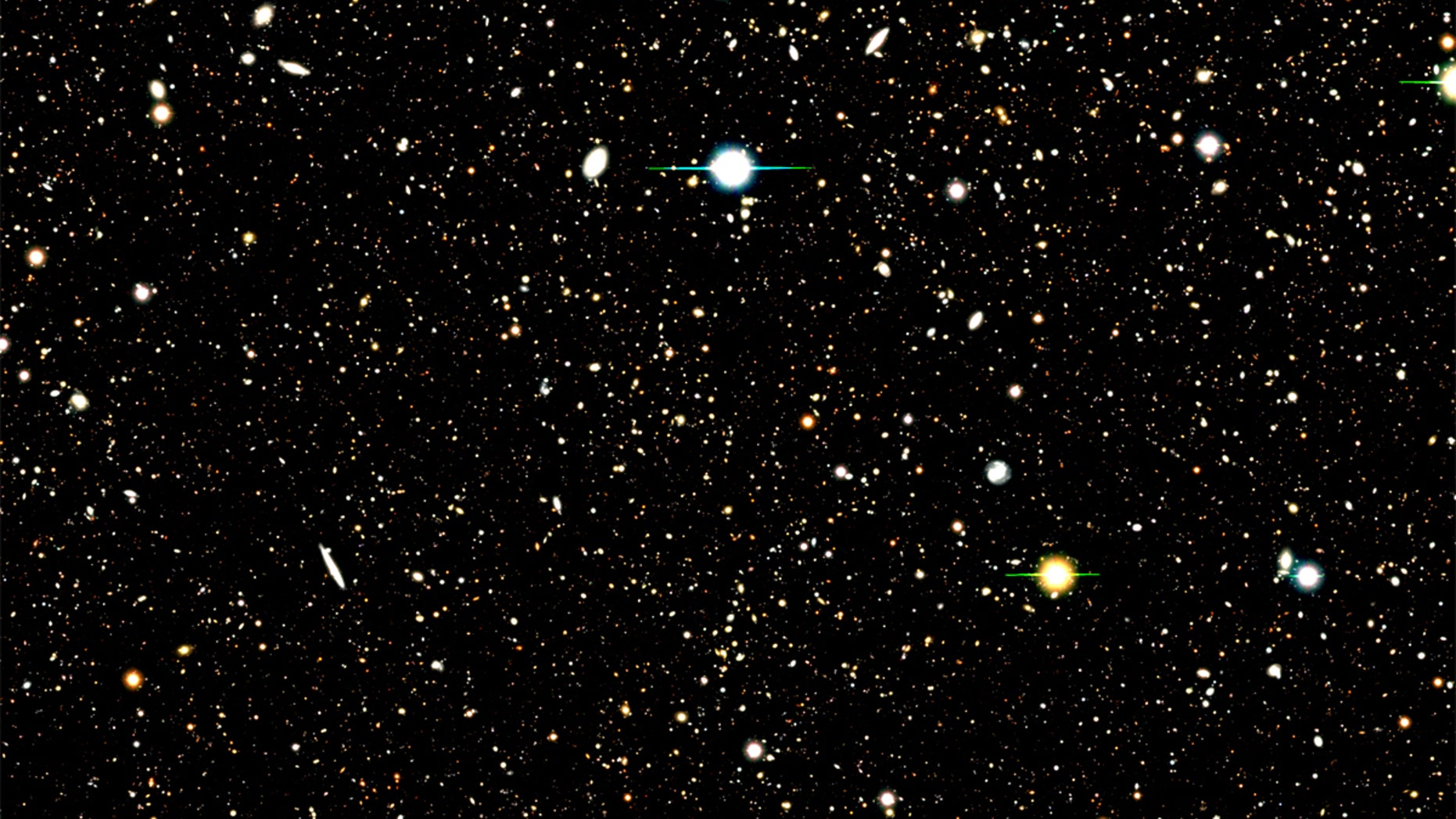 This image shows the results of a deep field survey by the Subaru Telescope. A new analysis used a Subaru deep field image to identify the location of nearly 1,300 distant galaxies. The analysis then combined the UV radiation from those galaxies to learn about their composition. A few bright supernovas can also be seen in the image.