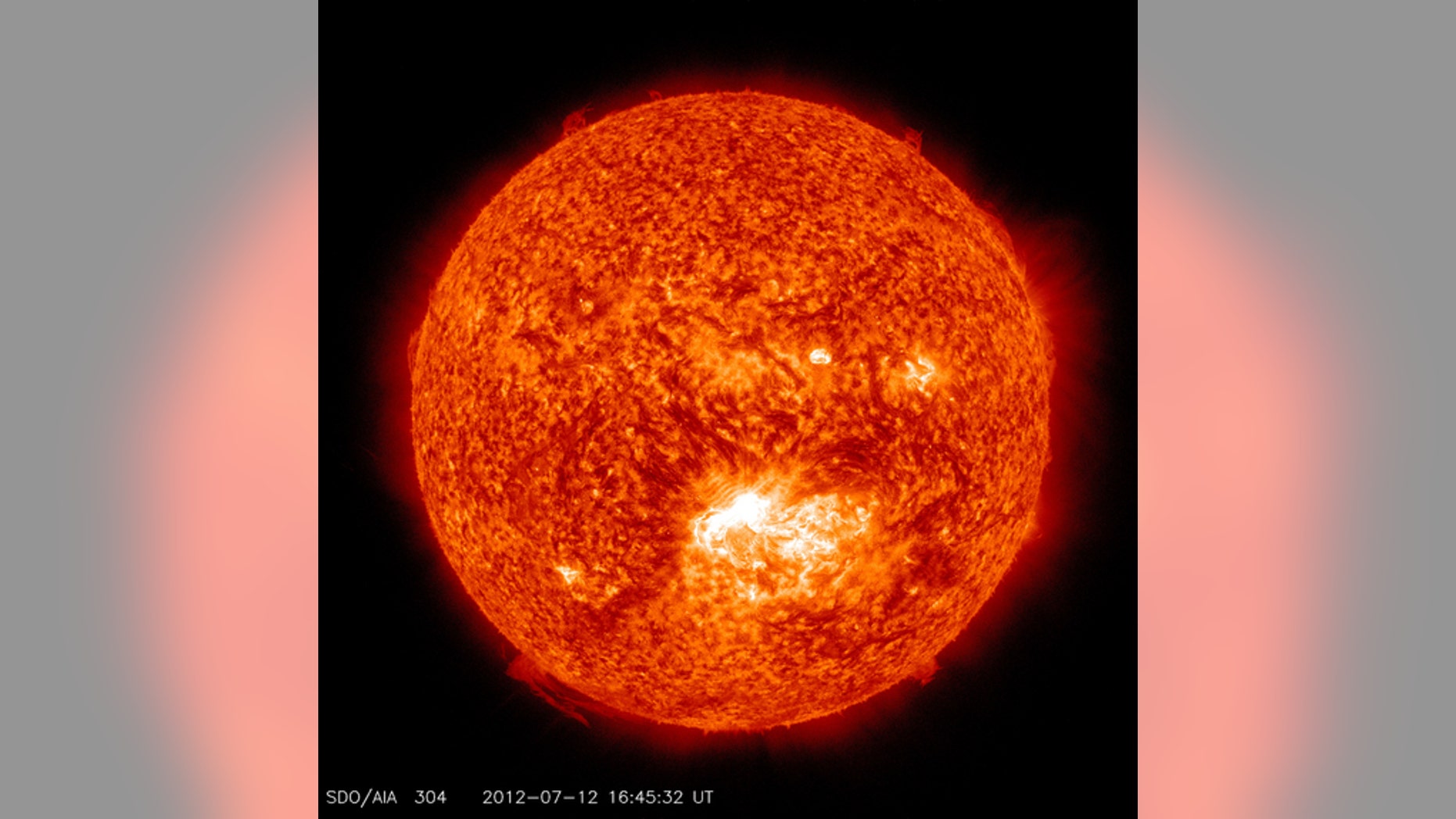 This image from the Solar Dynamics Observatory (SDO) shows the sun at 12:45 PM EDT on July 12, 2012 during an X1.4 class flare. The image is captured in the 304 Angstrom wavelength, which is typically colorized in red and shows temperatures in