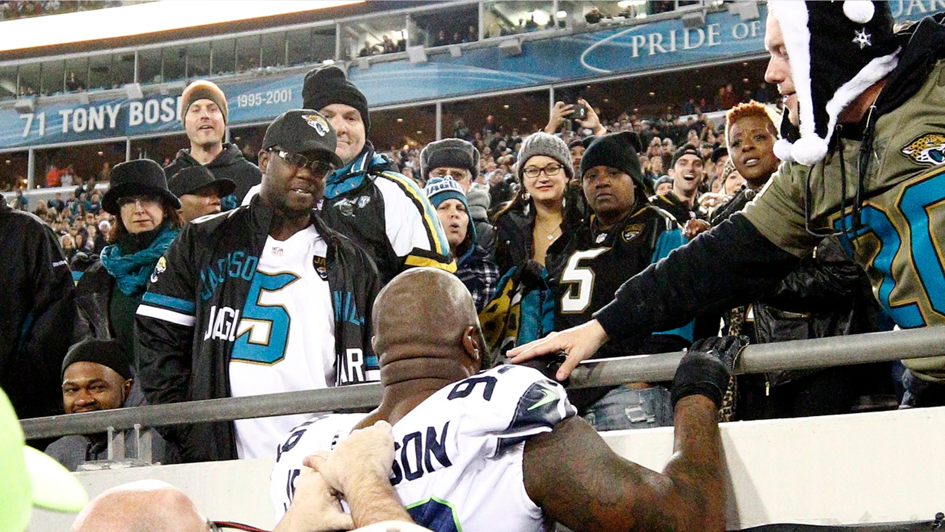 Dec. 10: Seattle Seahawks defensive tackle Quinton Jefferson tries to climb up in the stands after a fan threw an object in his direction.