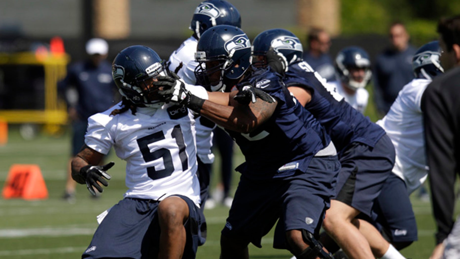 May 11, 2012: Bruce Irvin (51), the Seattle Seahawks' top NFL draft pick, tangles with Seahawks tackle Alex Barron, front right, during an NFL football rookie minicamp in Renton, Wash. (AP/Ted S. Warren)