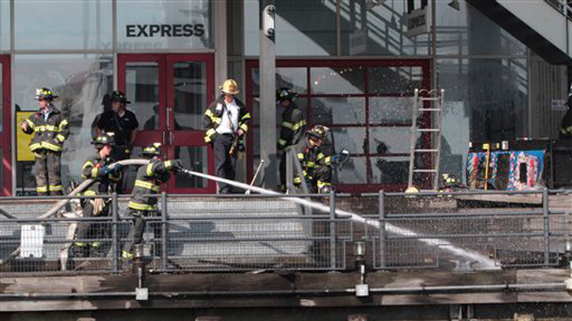 July 14, 2012: Firefighters work to extinguish a fire at PIer 17 in New York.