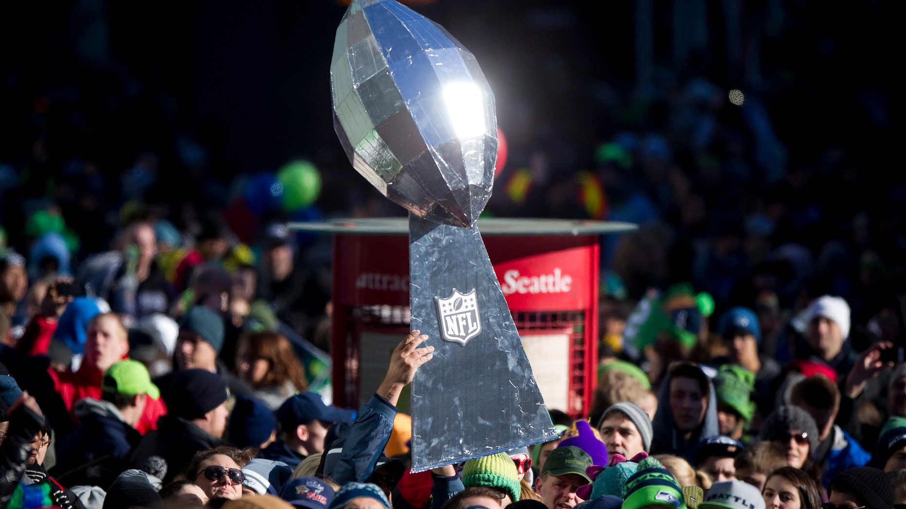 Feb. 5, 2014: A Seattle Seahawks fan holds a giant Lombardi Trophy Super Bowl during the NFL team's Super Bowl victory parade in Seattle, Washington.
