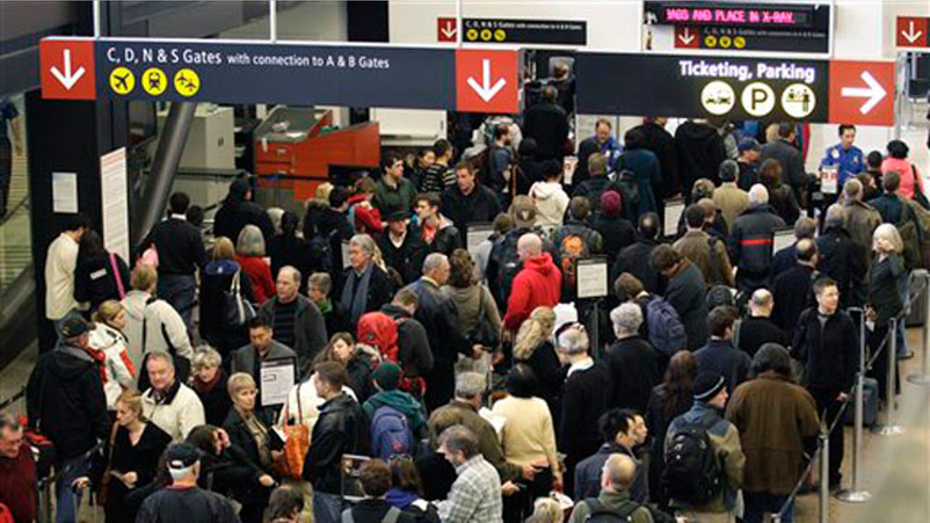 In this file photo taken Dec. 27, 2010, travelers wait in a TSA security checkpoint line at Seattle-Tacoma International Airport.