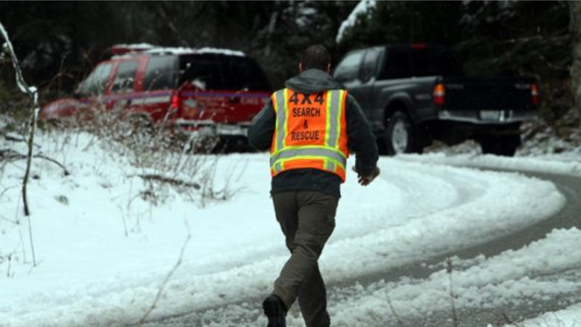 April 13, 2013: A man with King County Search and Rescue runs toward scene of avalanche at exit 47 along I-90 near Snoqualmie Pass.