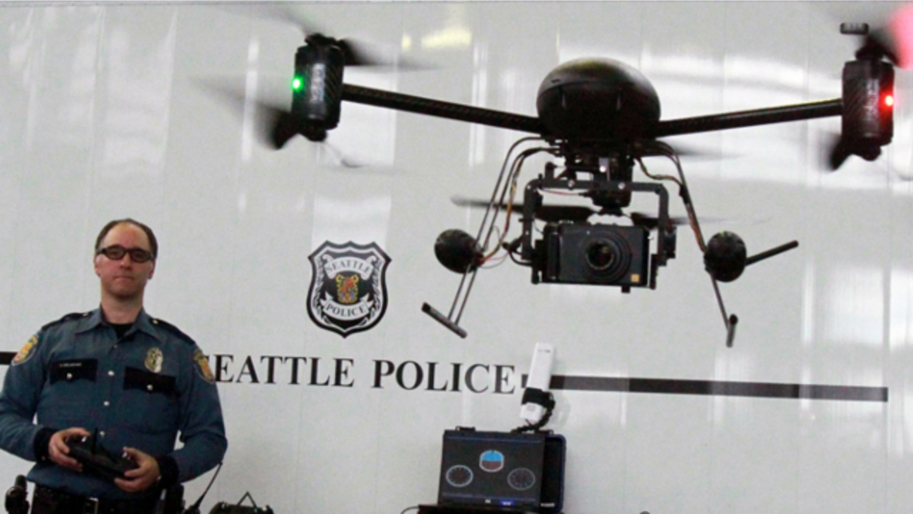 April 27, 2012: Seattle Police officer Reuben Omelanchuk is at the controls of the department's new, small radio-controlled Draganflyer X6 drone with a camera attached, in Seattle.