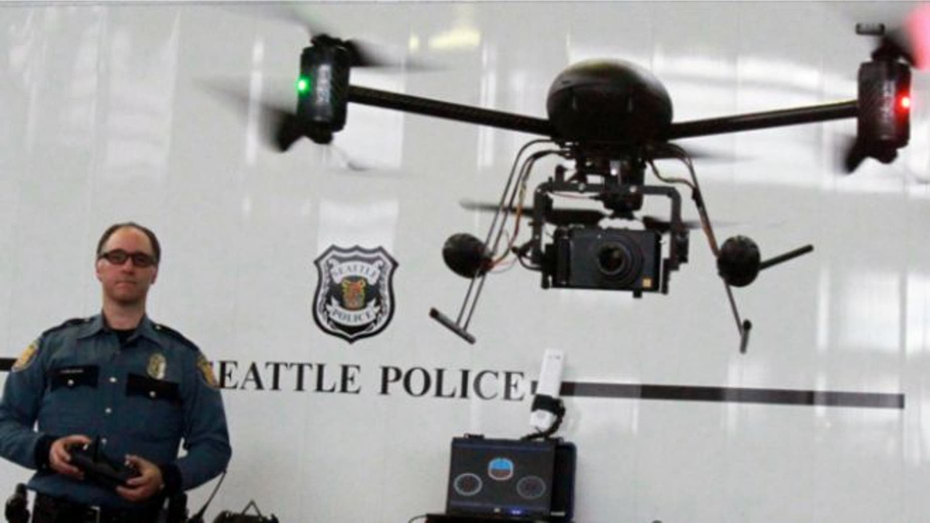 April 27, 2012: Seattle Police officer Reuben Omelanchuk is at the controls of the department's new, small radio-controlled Draganflyer X6 drone with a camera attached, in Seattle.