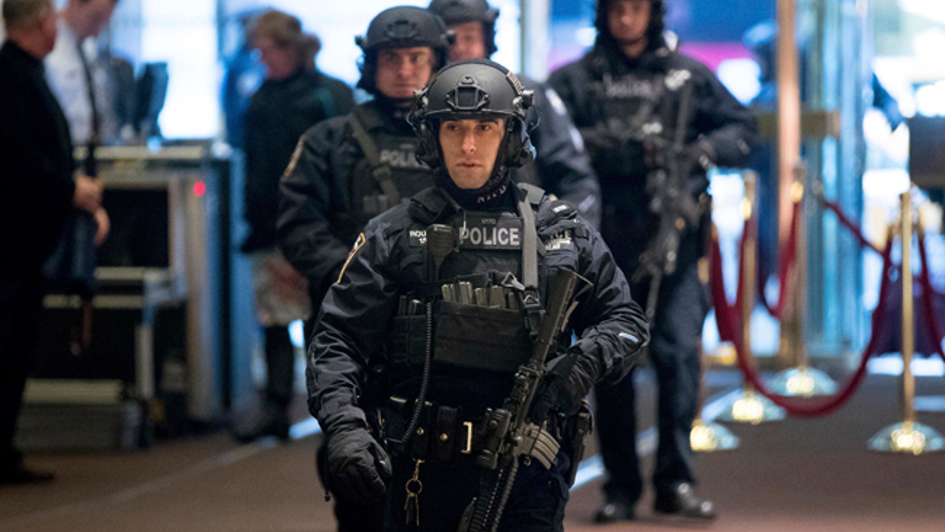Police officers walk through the lobby of Trump Tower in New York City.