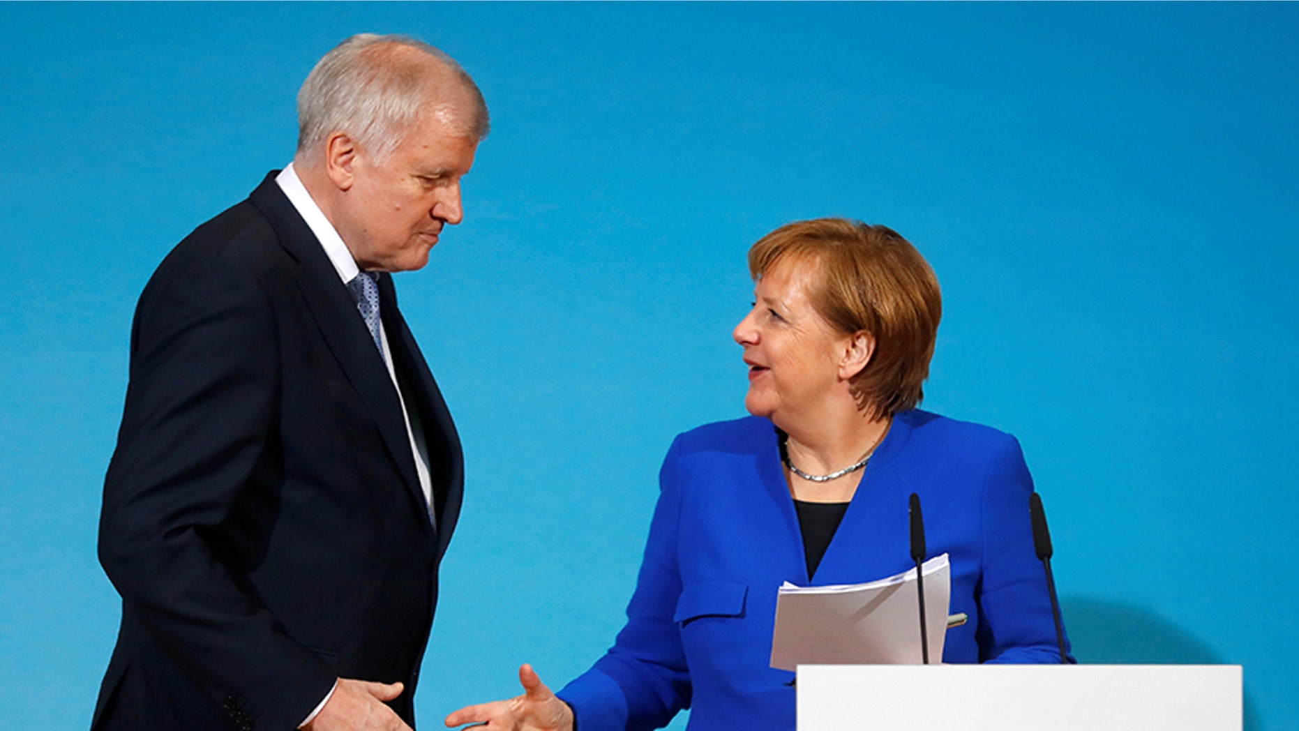 Interior Minister Horst Seehofer, seen here with Chancellor Angela Merkel, has promised a tougher line on migration.