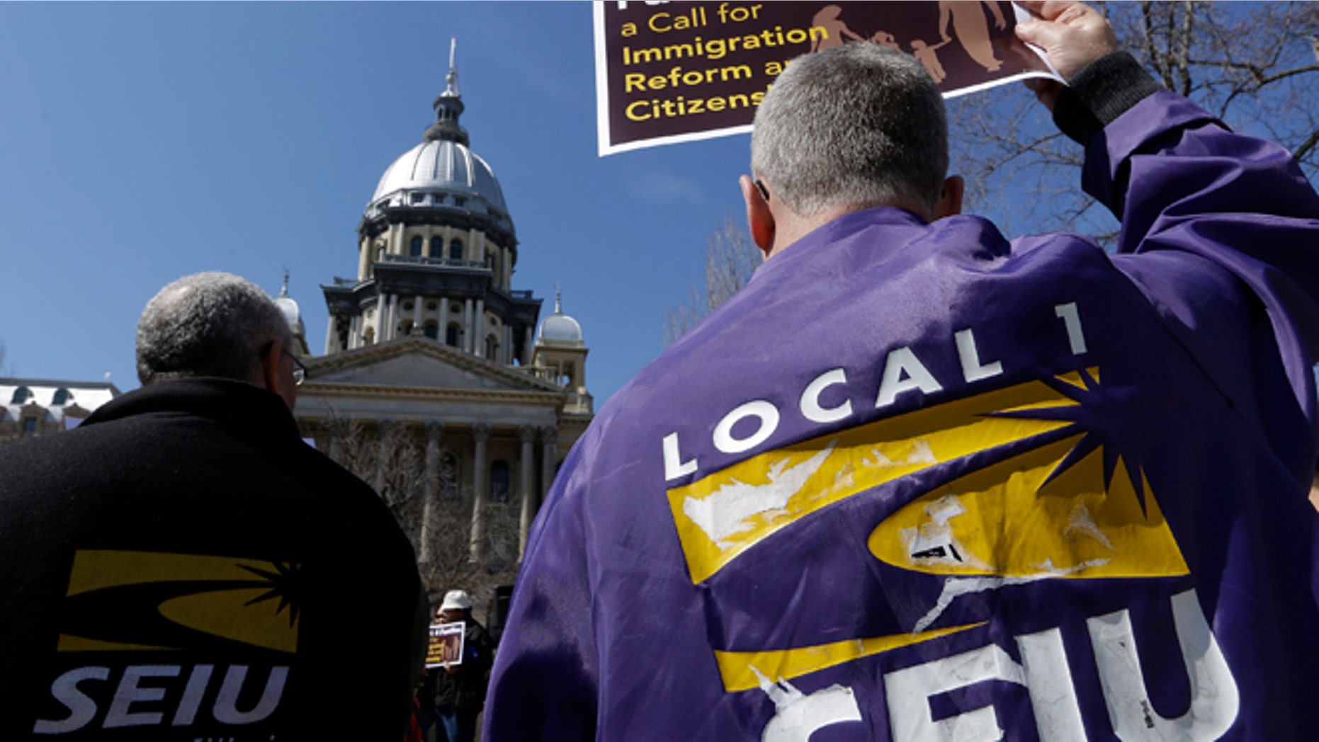 In this March 20, 2014 file photo, members of the Service Employees International Union, SEIU, rally in front of the Illinois State Capitol in support of Immigration changes.