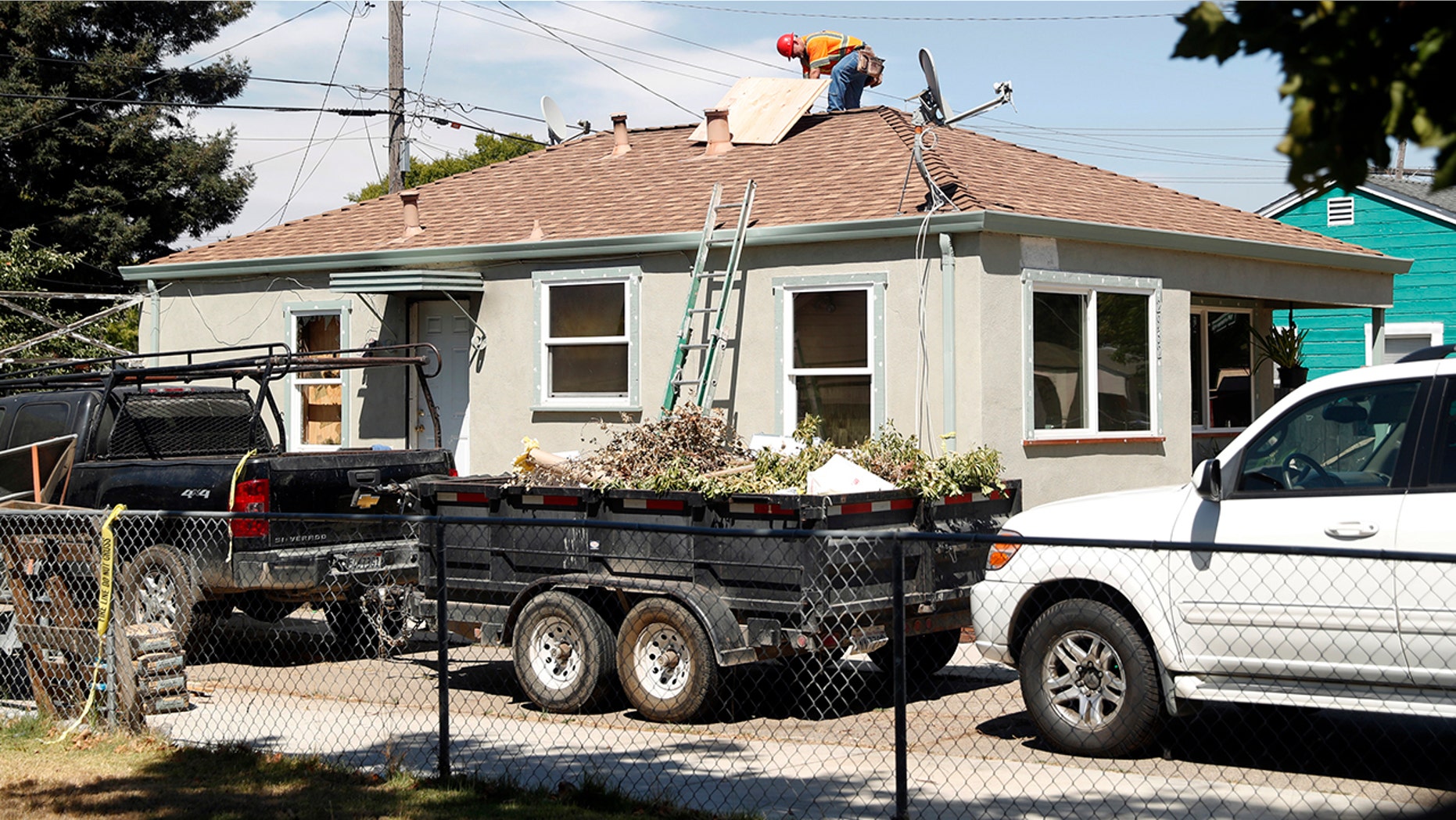 Construction crews work at a house in Vallejo, Calif., after a deadly fire, Aug. 5, 2018.