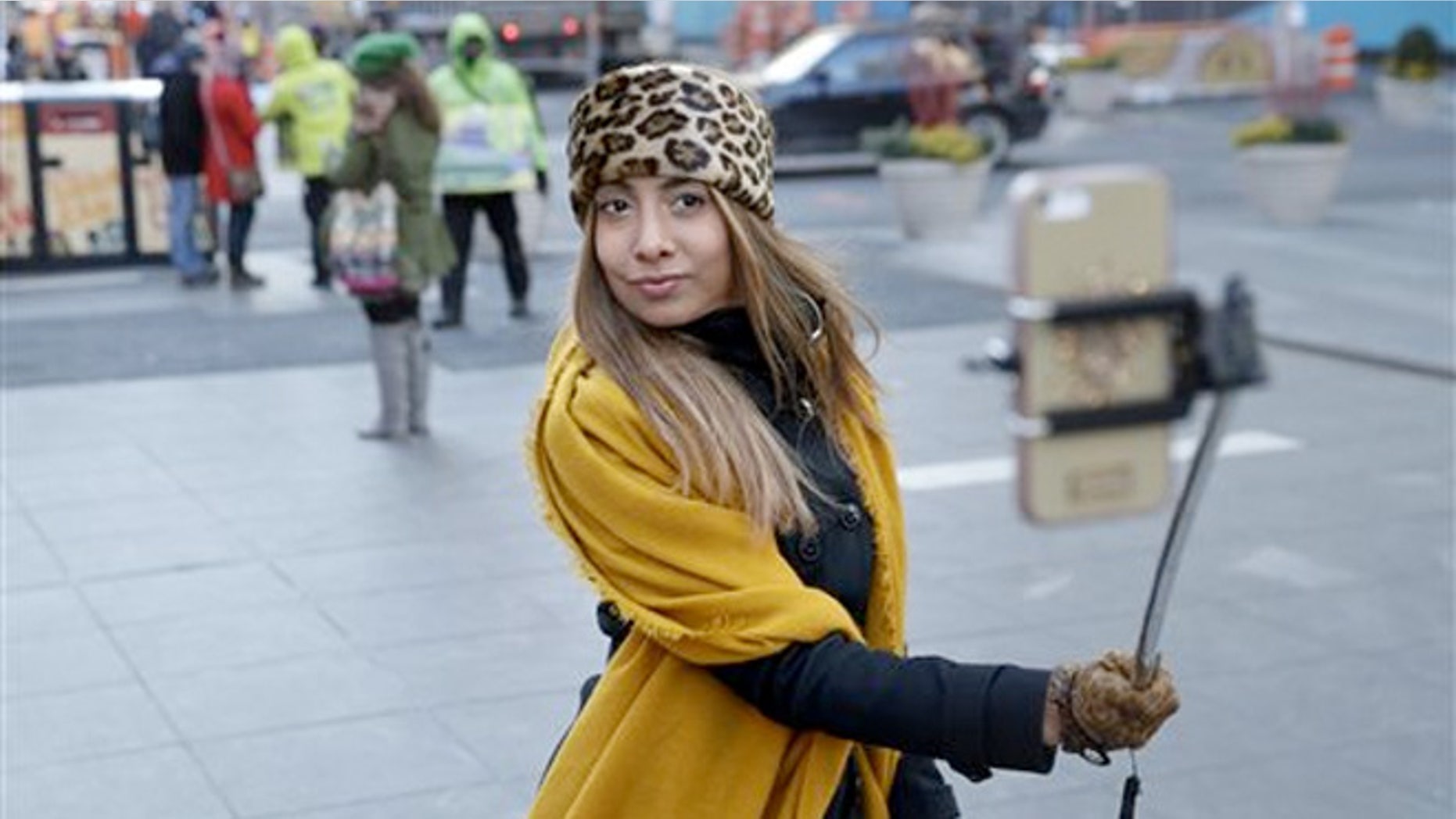 Jan. 8, 2015: Sandy Johal uses a selfie stick to take a picture of herself in Times Square in New York.