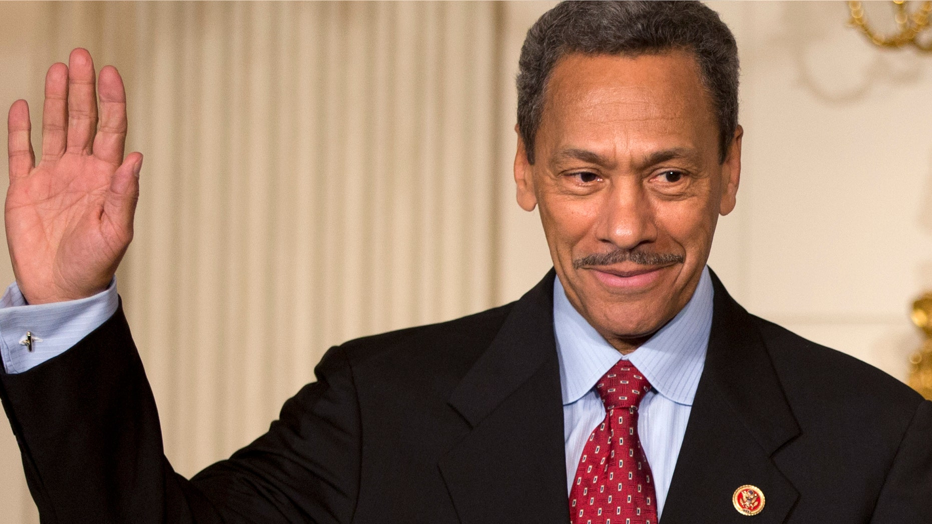 Rep. Mel Watt, D-N.C., waves during the announcement of his nomination in the State Dining Room of the White House in Washington.