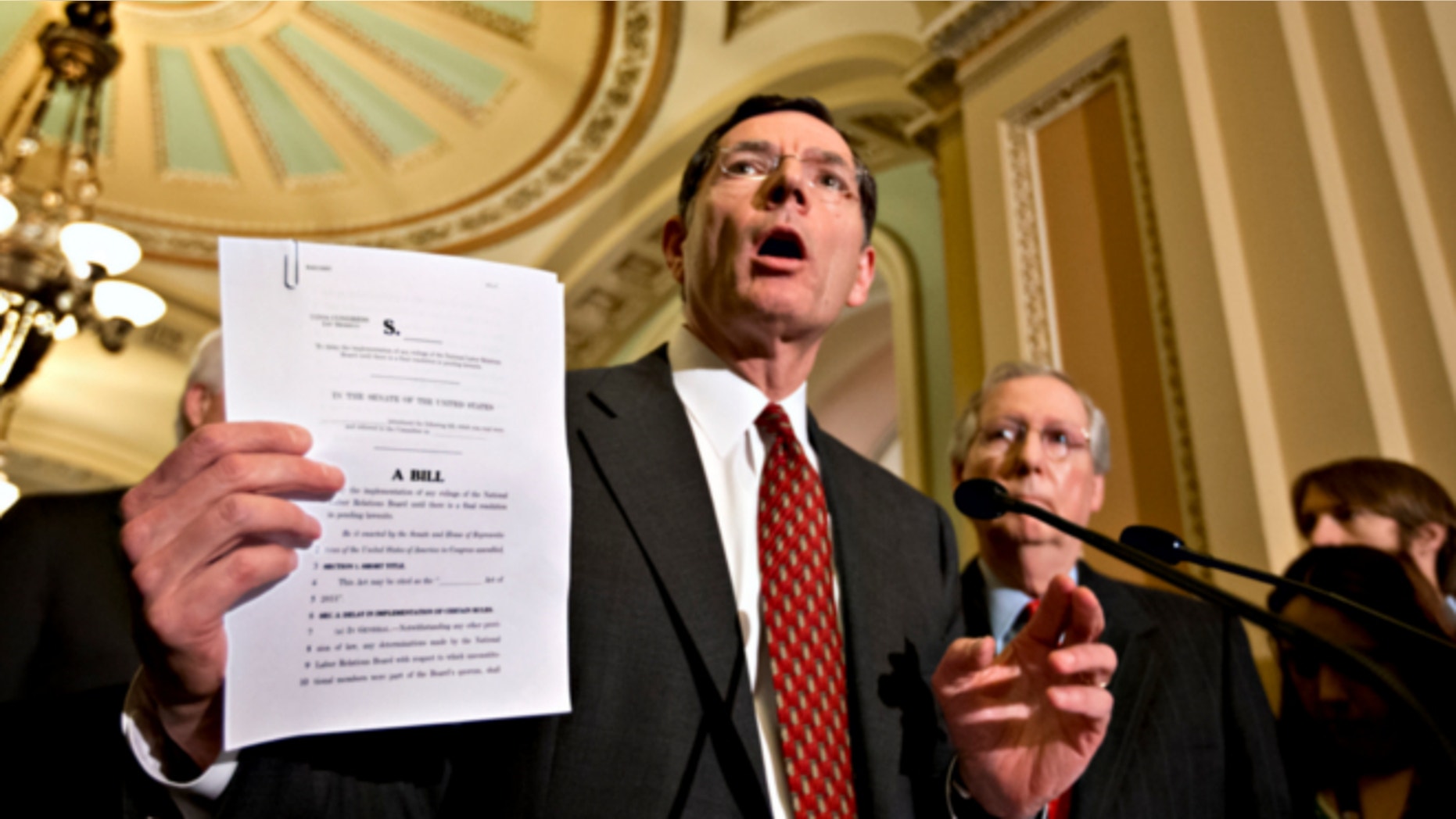 Jan. 29, 2013: Sen. John Barrasso, R-Wyo., holds up a bill he plans to introduce that would forestall any new National Labor Relations Board rules or regulations.