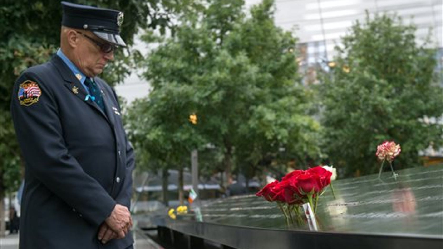 Retired New York City firefighter Joseph McCormick visits the South Pool prior to a ceremony at the World Trade Center site in New York on Friday, Sept. 11, 2015. (AP Photo/Bryan R. Smith)