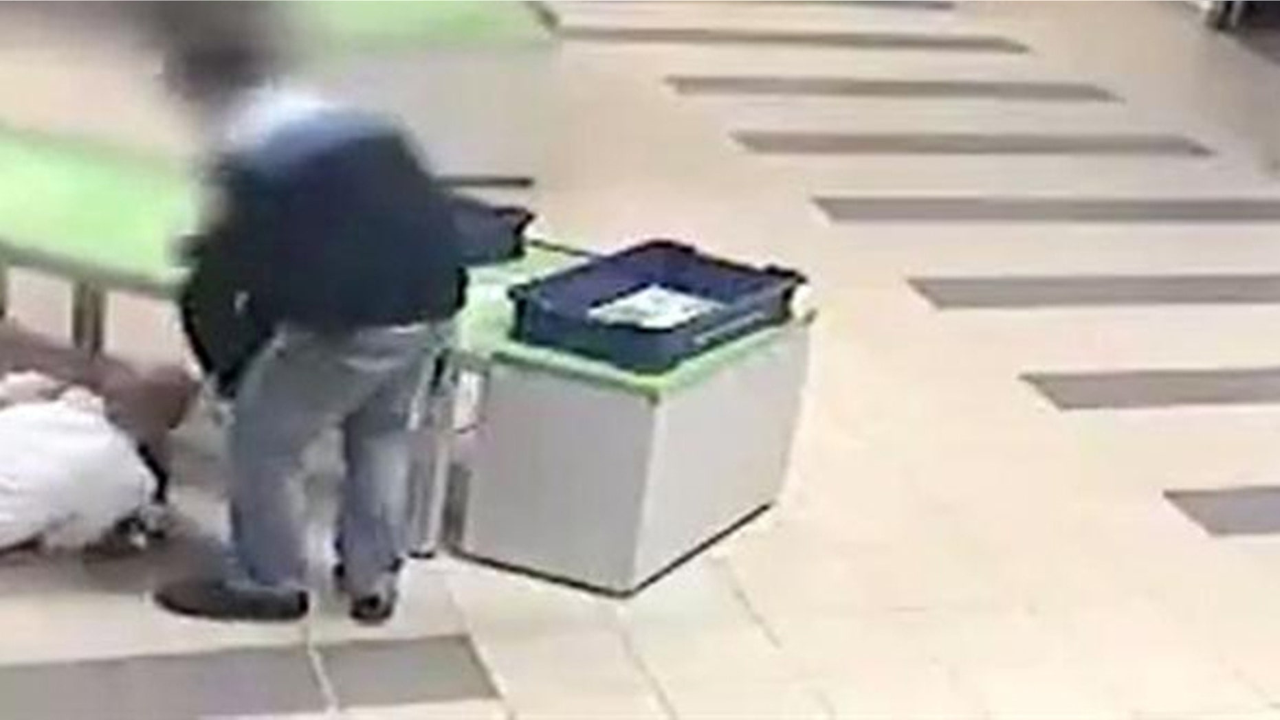 A quick thinking security guard at Katowice airport in Poland saved a toddler from injury by diving to catch him before the child fell off a table.