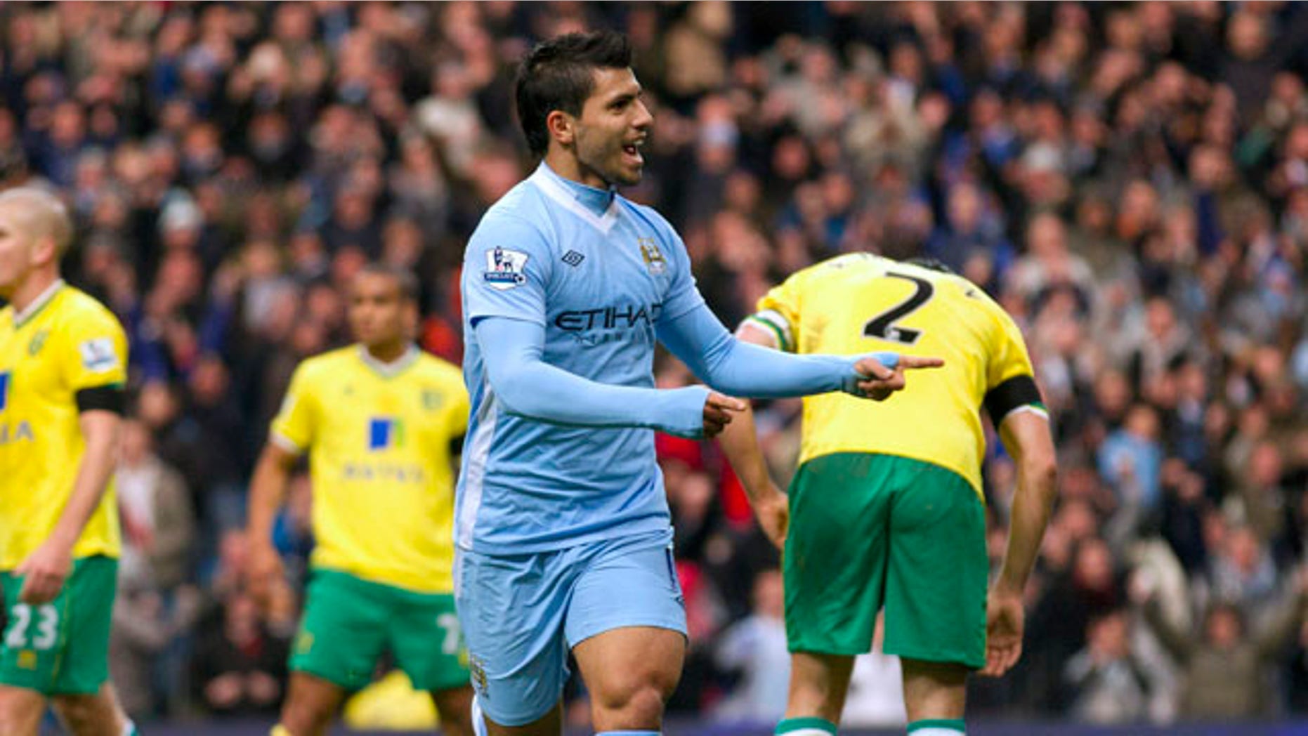 Manchester City's Sergio Aguero, center right, celebrates after scoring against Norwich during their English Premier League soccer match at The Etihad Stadium, Manchester, England, Saturday Dec. 3, 2011. (AP Photo/Jon Super)
