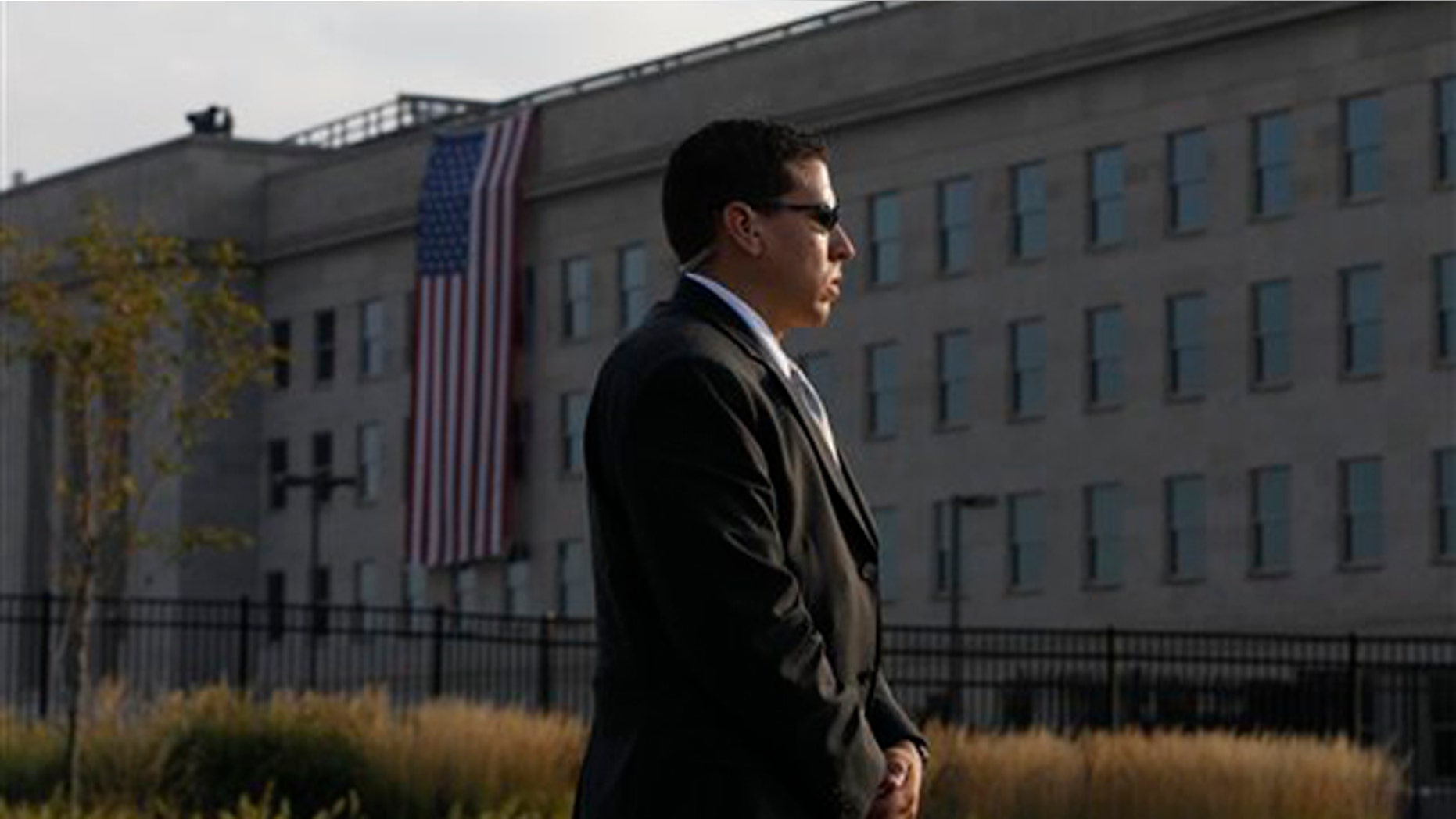A U.S. Secret Service agent stands watch outside the Pentagon before the start of ceremonies for the 10th commemoration of the Sept. 11 attacks.