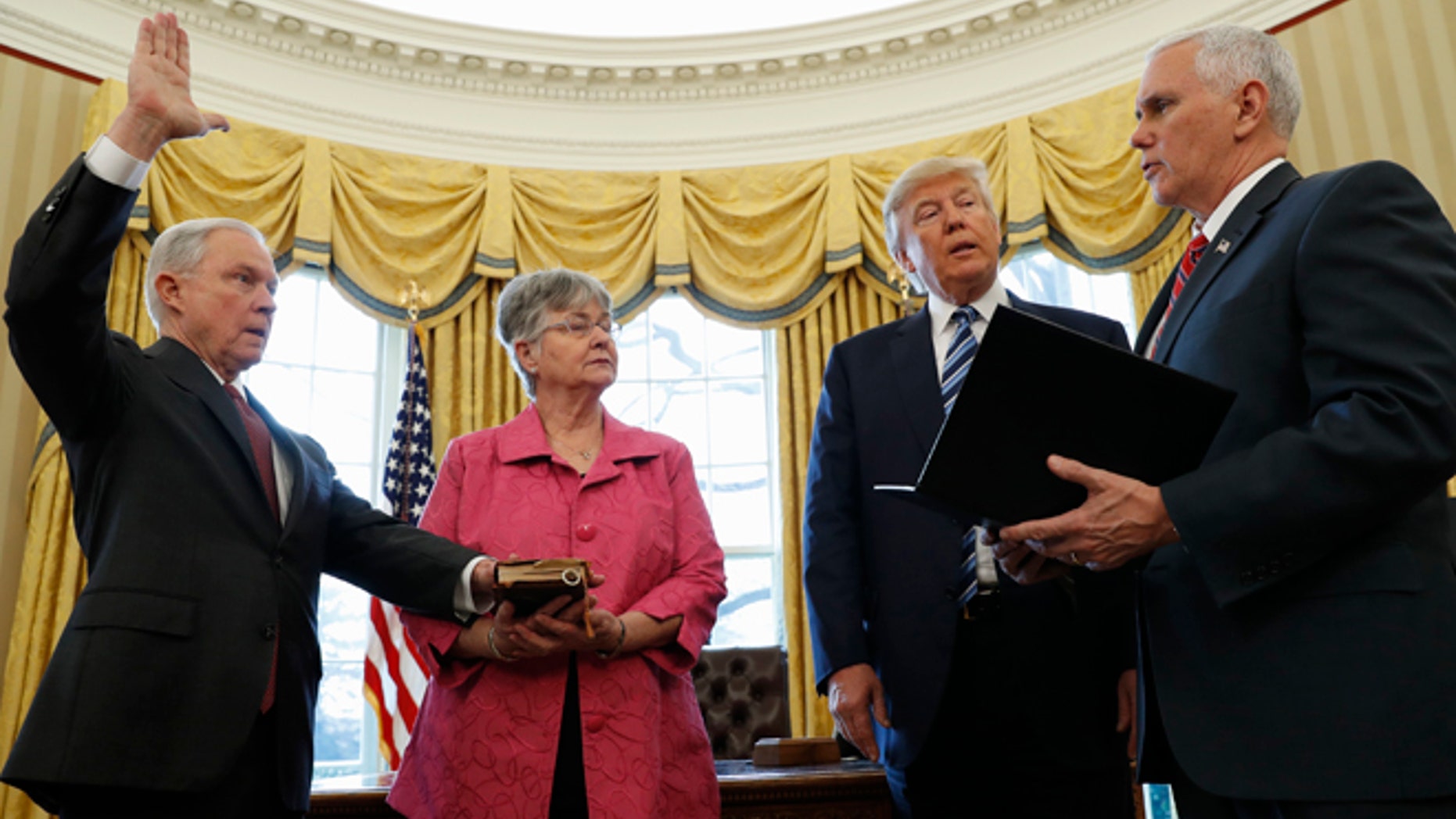 Feb. 9, 2017: President Donald Trump watches as Vice President Mike Pence administers the oath of office to Attorney General Jeff Sessions, accompanied by his wife Mary in the Oval Office of the White House in Washington.
