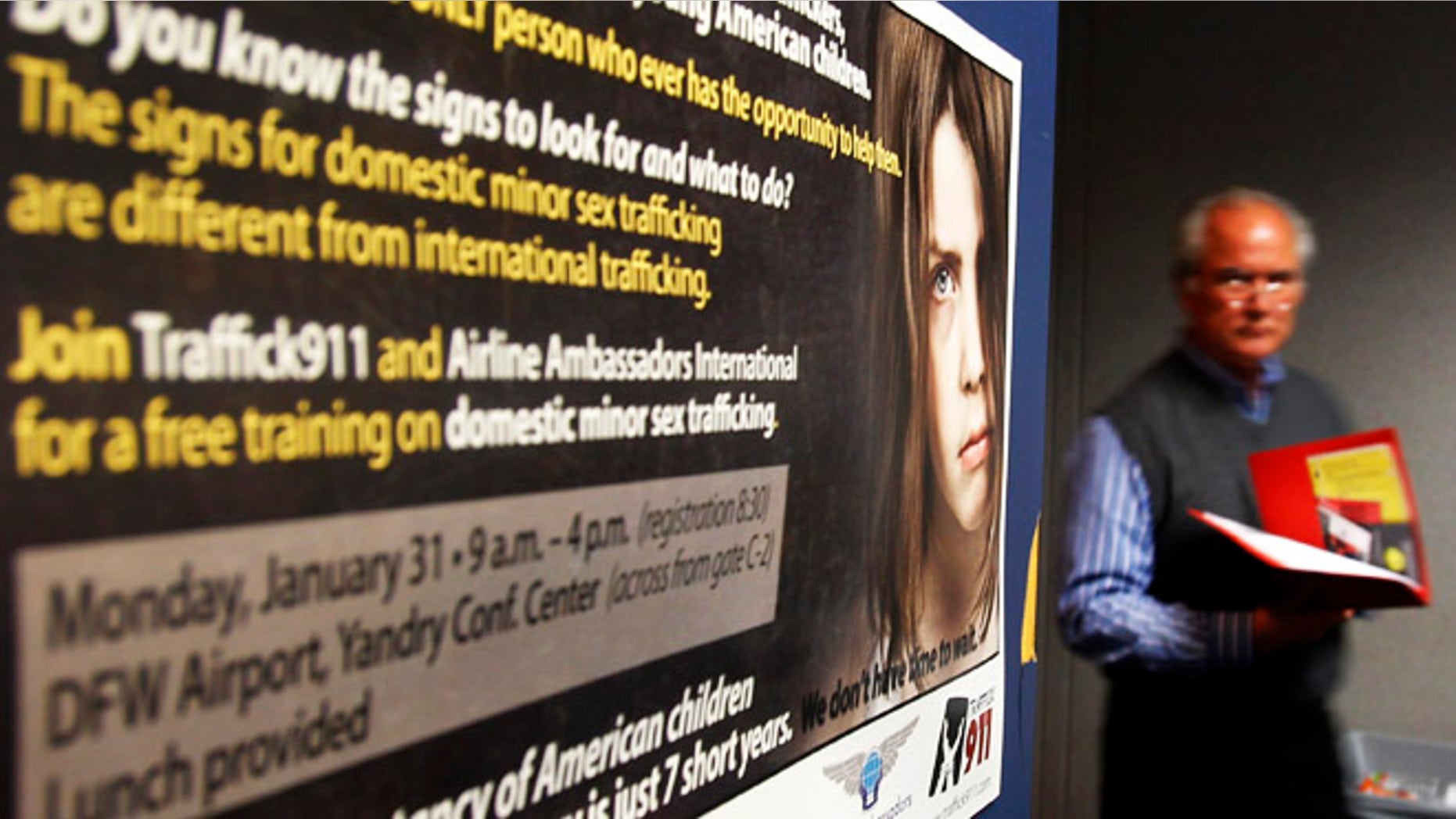 A participant in a training program walks past a poster drawing attention to sex-trafficking at Dallas Fort Worth International Airport in Dallas, Texas, January 31, 2011 ahead of NFL football's Super Bowl XLV to be played February 6. Pimps will traffic thousands of under-age prostitutes to Texas for Sunday's Super Bowl, hoping to do business with men arriving for the big game with money to burn, child rights advocates said. REUTERS/Brian Snyder (UNITED STATES - Tags: SPORT FOOTBALL CRIME LAW SOCIETY) - RTXXC3I