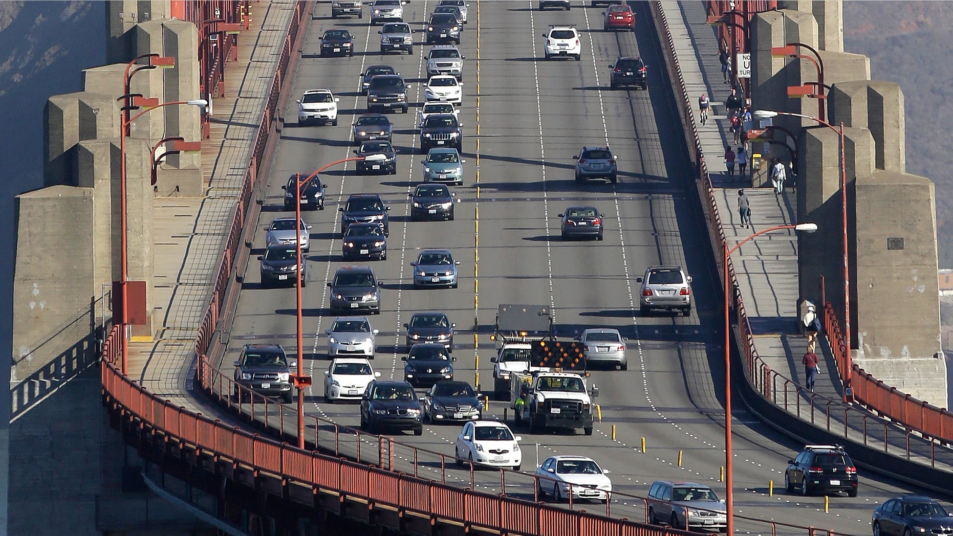 Sept. 19, 2013: Golden Gate Bridge workers shift traffic lanes during the end of the morning commute in San Francisco.