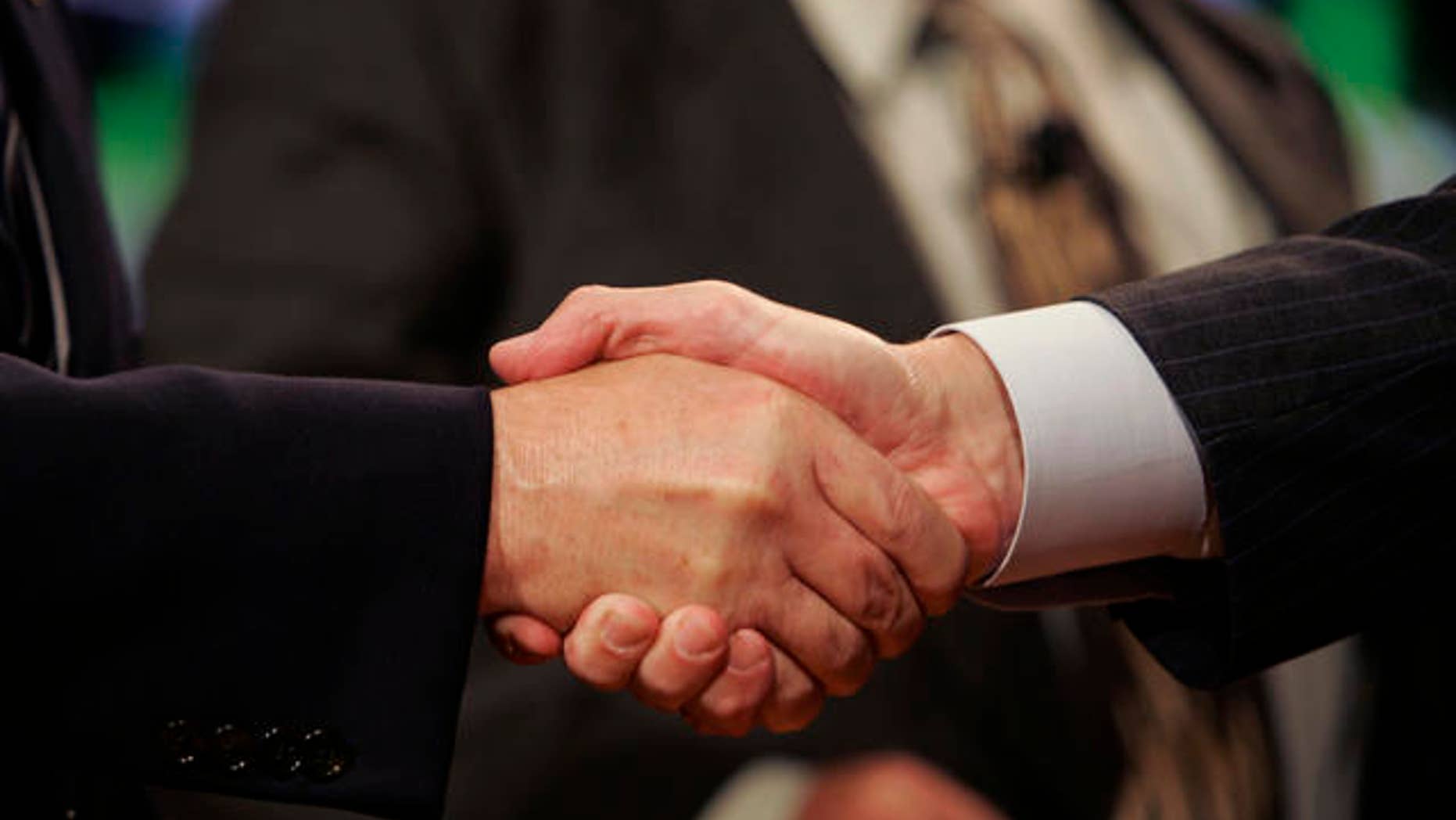 United Auto Workers President Ron Gettelfinger, left, and General Motors Chairman and CEO Rick Wagoner shake hands to open their contract talks at the UAW/GM Center for Human Resources in Detroit, Monday, July 23, 2007. The national contract between the UAW and the automakers expires Sept. 14. (AP Photo/Carlos Osorio)