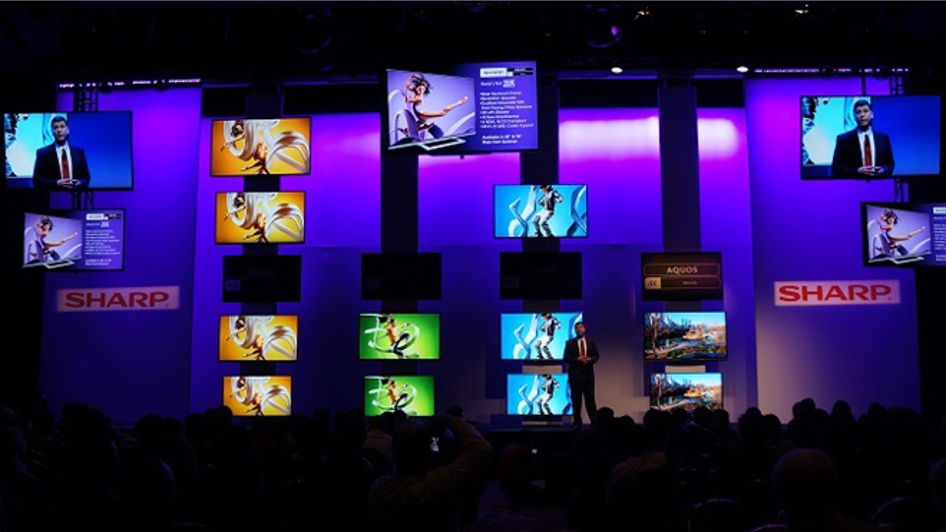 A Sharp executive speaks onstage during a presentation at the 2014 Consumer Electronics Show.