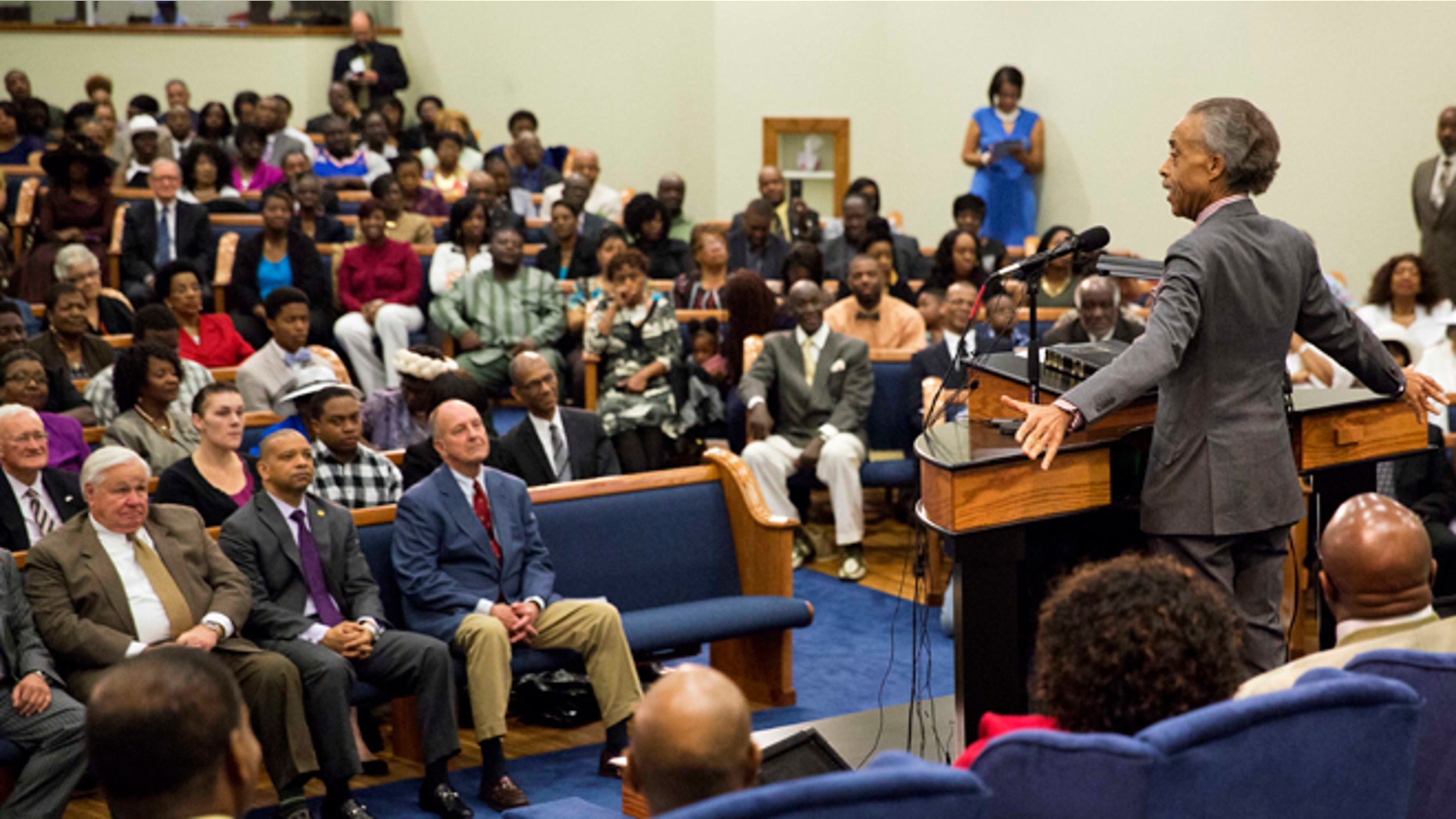 April 12, 2015: The Rev. Al Sharpton, right, speaks during a service at Charity Missionary Baptist Church in the wake of the death of Walter Scott, the black driver who was fatally shot by a white police officer after he fled a traffic stop, in North Charleston, S.C.