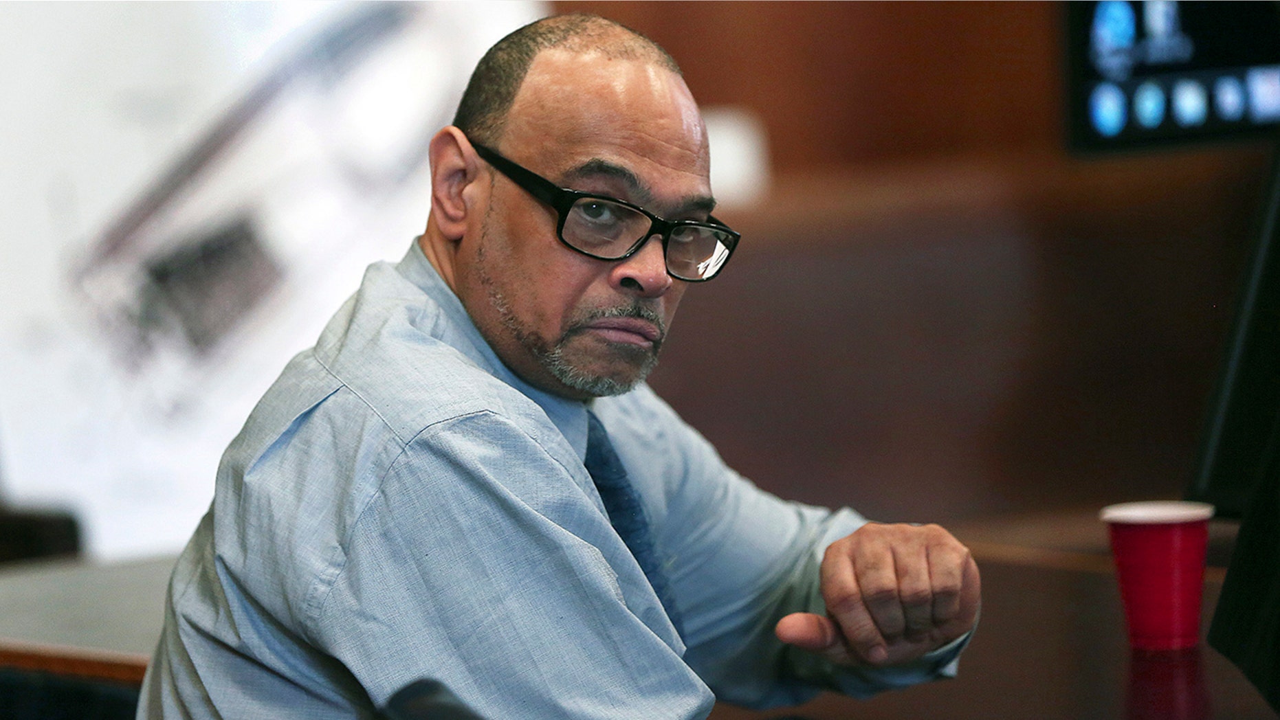 In this May 30, 2018, photo, Shaun Harrison reacts as attorneys give closing arguments in Suffolk Superior Court in the jury trial of him in Boston.