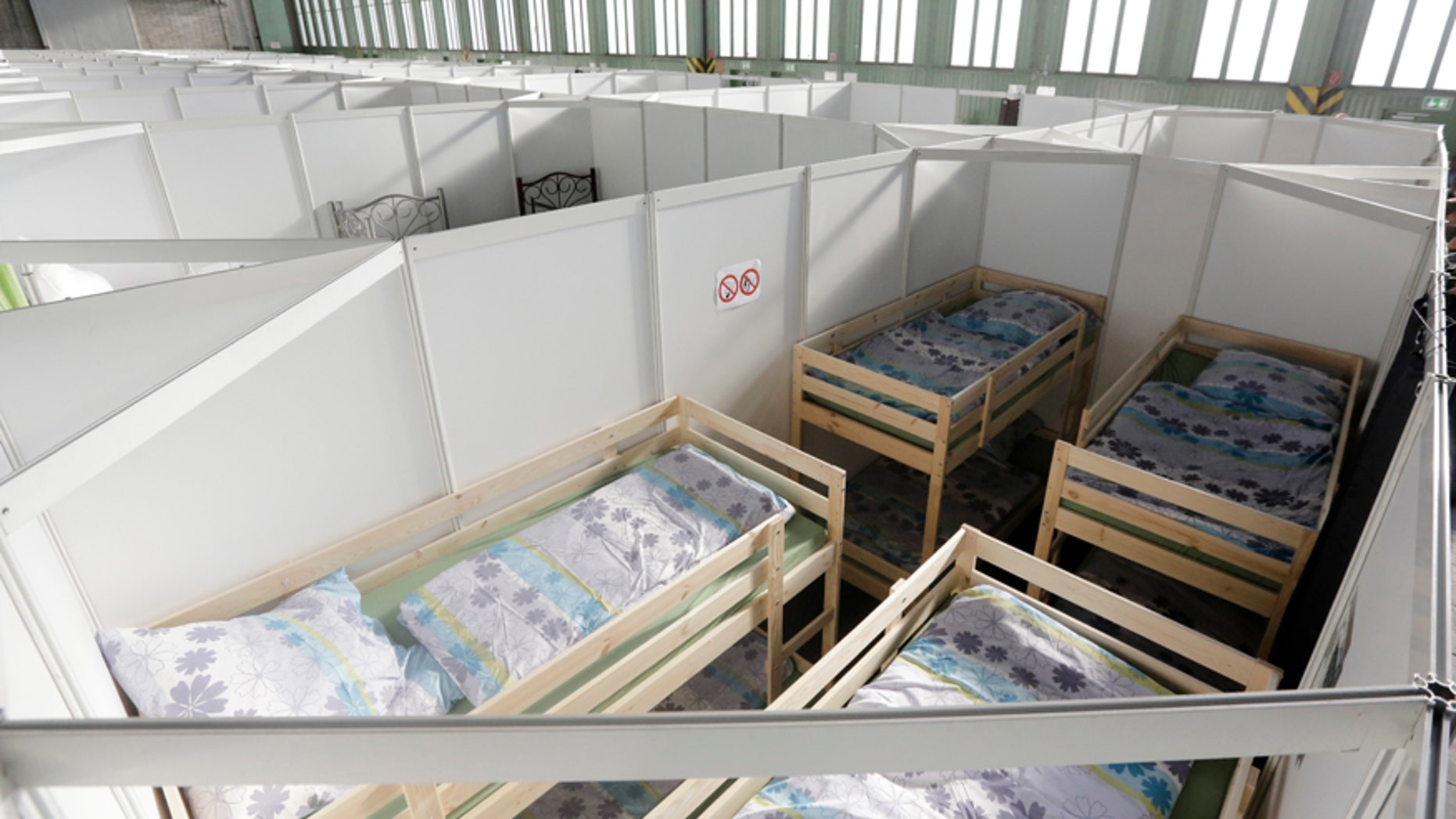 Dec. 9, 2015: Cabins are set up inside Hanger 4 of the former airport Tempelhof to be used as a temporary emergency shelter for migrants, refugees and asylum seekers in Berlin