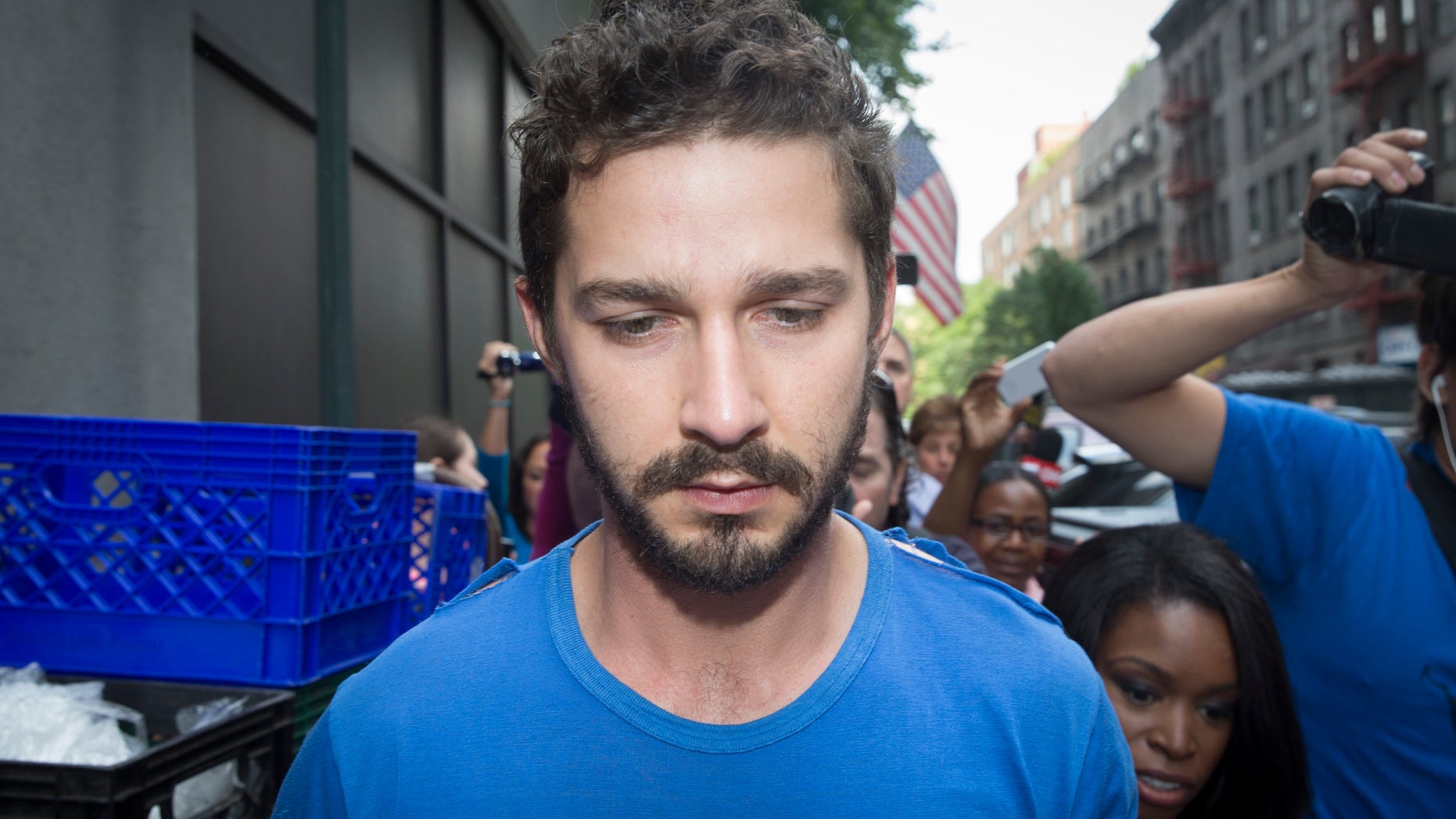 June 27, 2014. Actor Shia LaBeouf is followed by media after leaving Midtown Community Court following his arrest the previous day for yelling obscenities at the Broadway show "Cabaret."