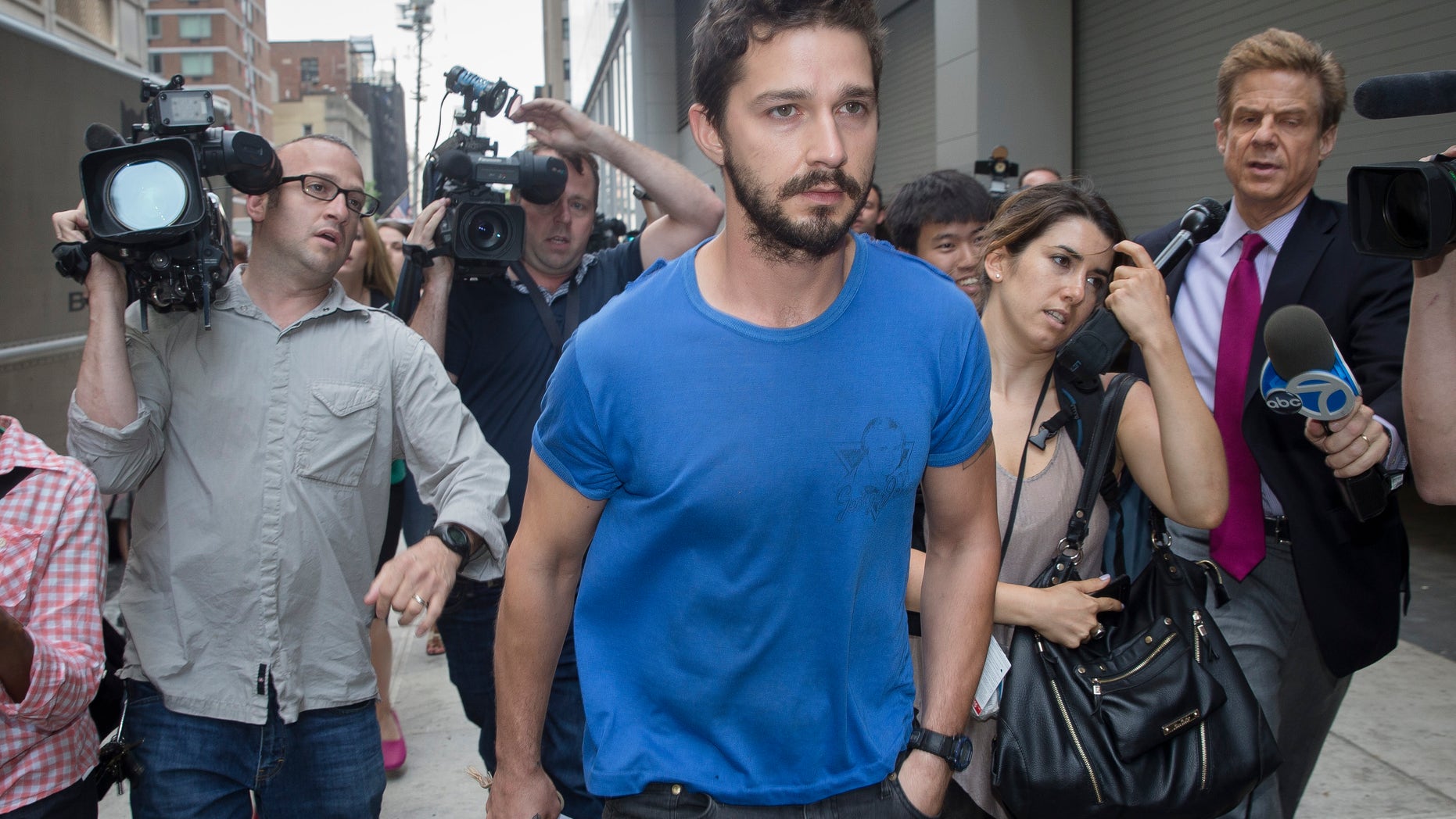 June 27, 2014. Actor Shia LaBeouf walks through the media after leaving Midtown Community Court following his arrest the previous day for yelling obscenities at the Broadway show "Cabaret."