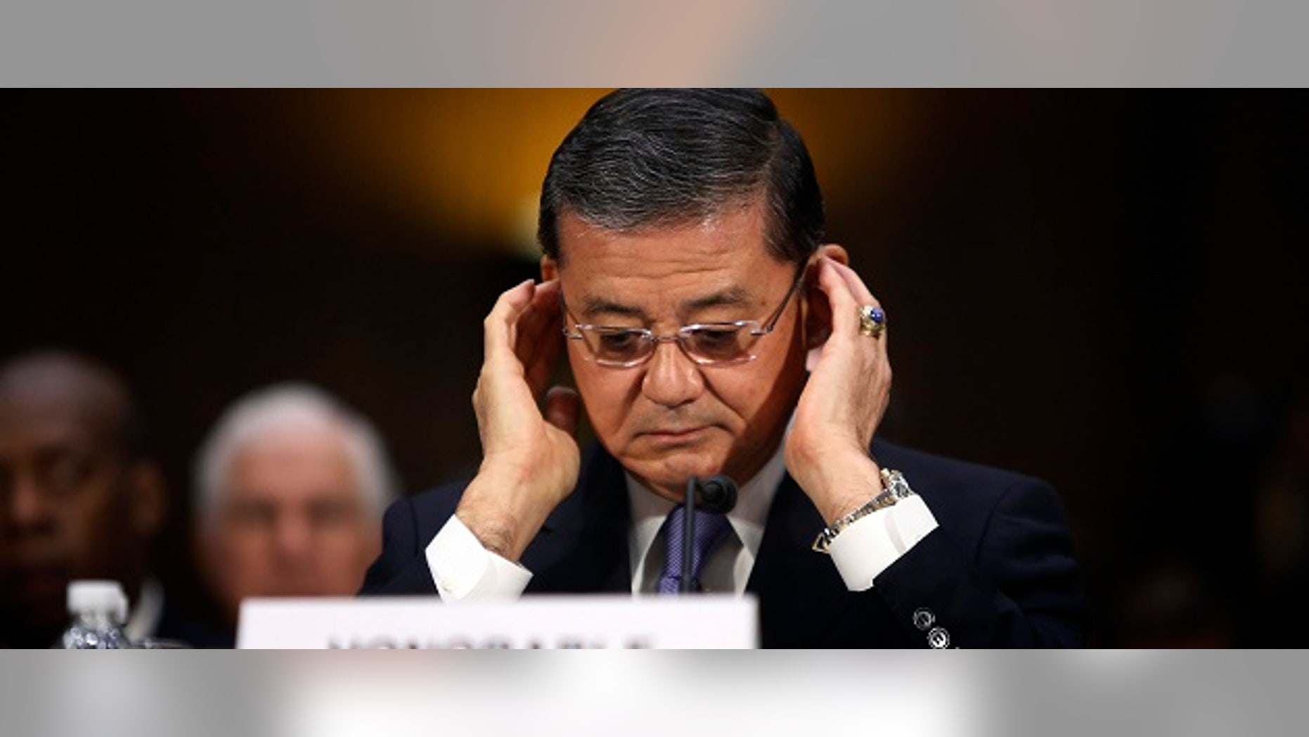 U.S. Department of Veterans Affairs Secretary Eric Shinseki adjusts his glasses as he takes his seat to testify before a Senate Veterans Affairs Committee hearing on VA health care, on Capitol Hill in Washington May 15, 2014. REUTERS/Jonathan Ernst (UNITED STATES - Tags: POLITICS MILITARY HEALTH) - RTR3PBJR