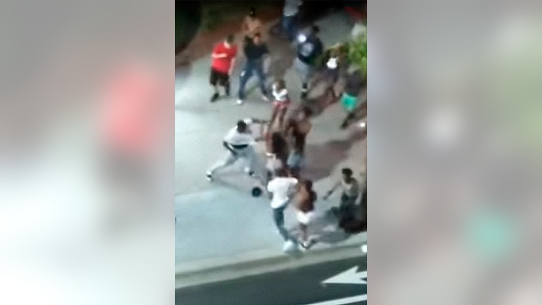 Screen shot from Facebook Live video that captured a shooting early Sunday in Myrtle Beach, S.C., shows man in white t-shirt reaching for a gun.